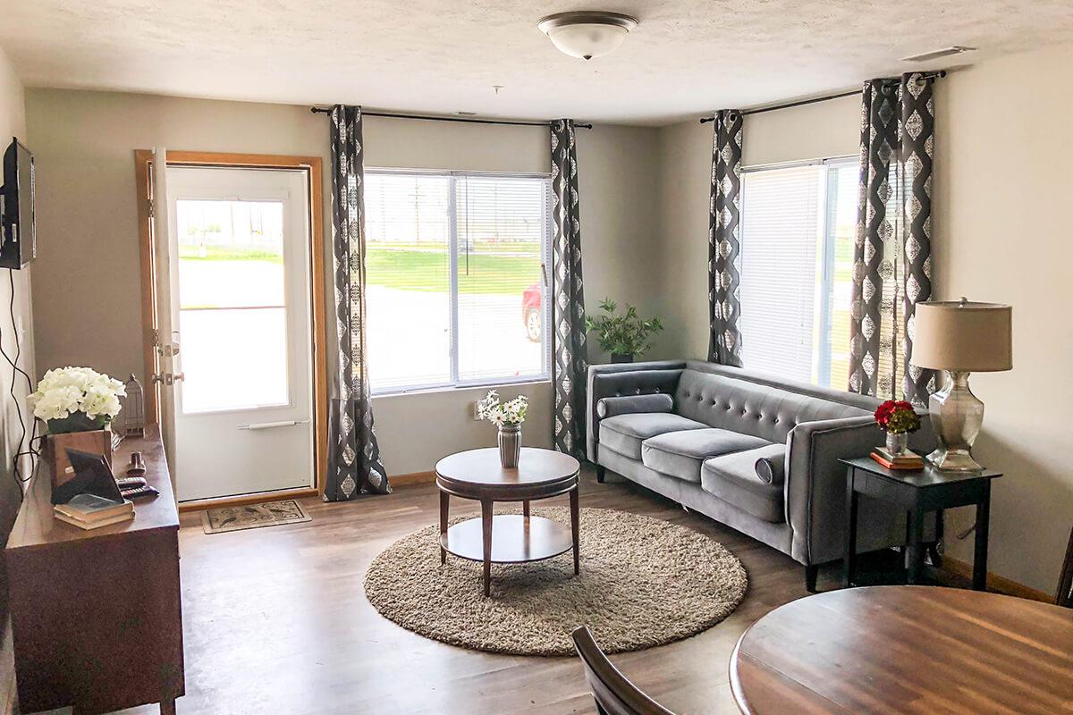 a living room filled with furniture and a large window