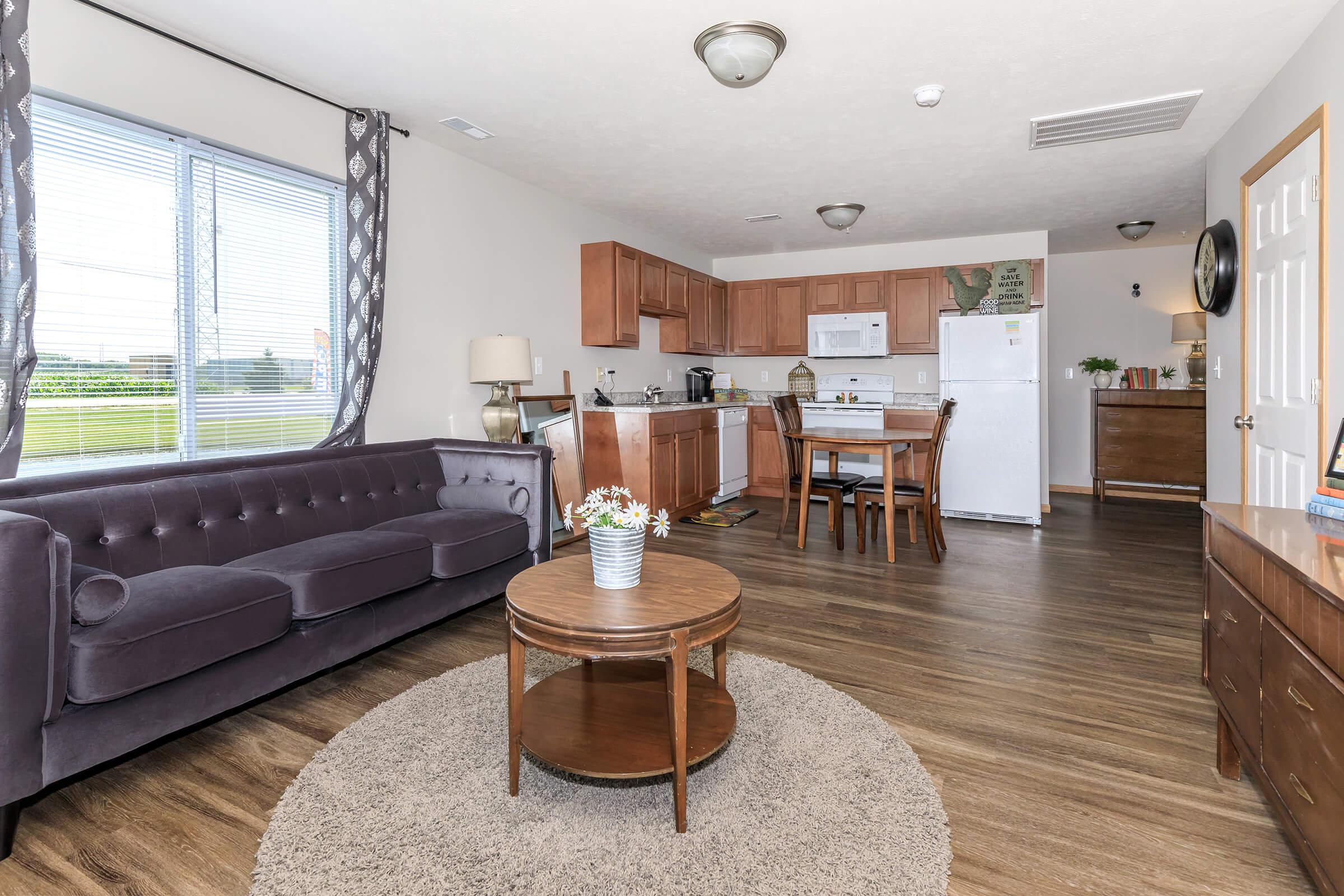 a living room filled with furniture and a large window