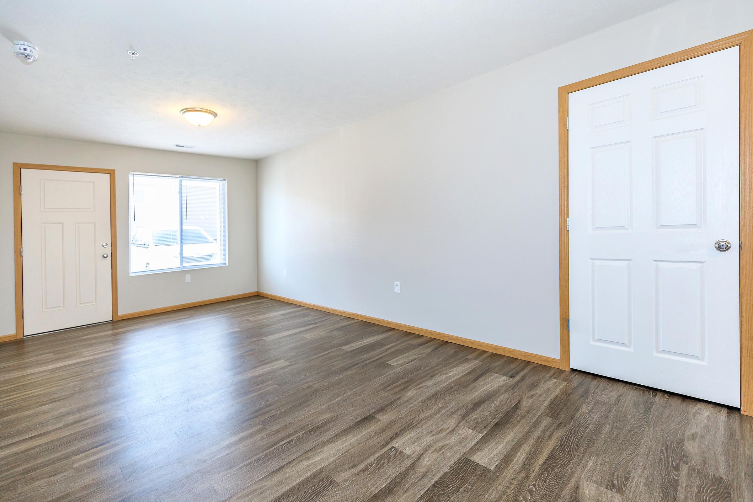 a large empty room with a wooden floor