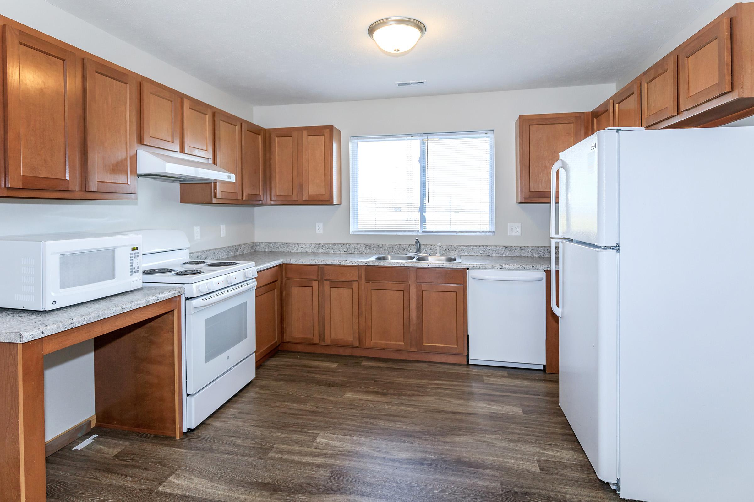 a kitchen with a wood floor