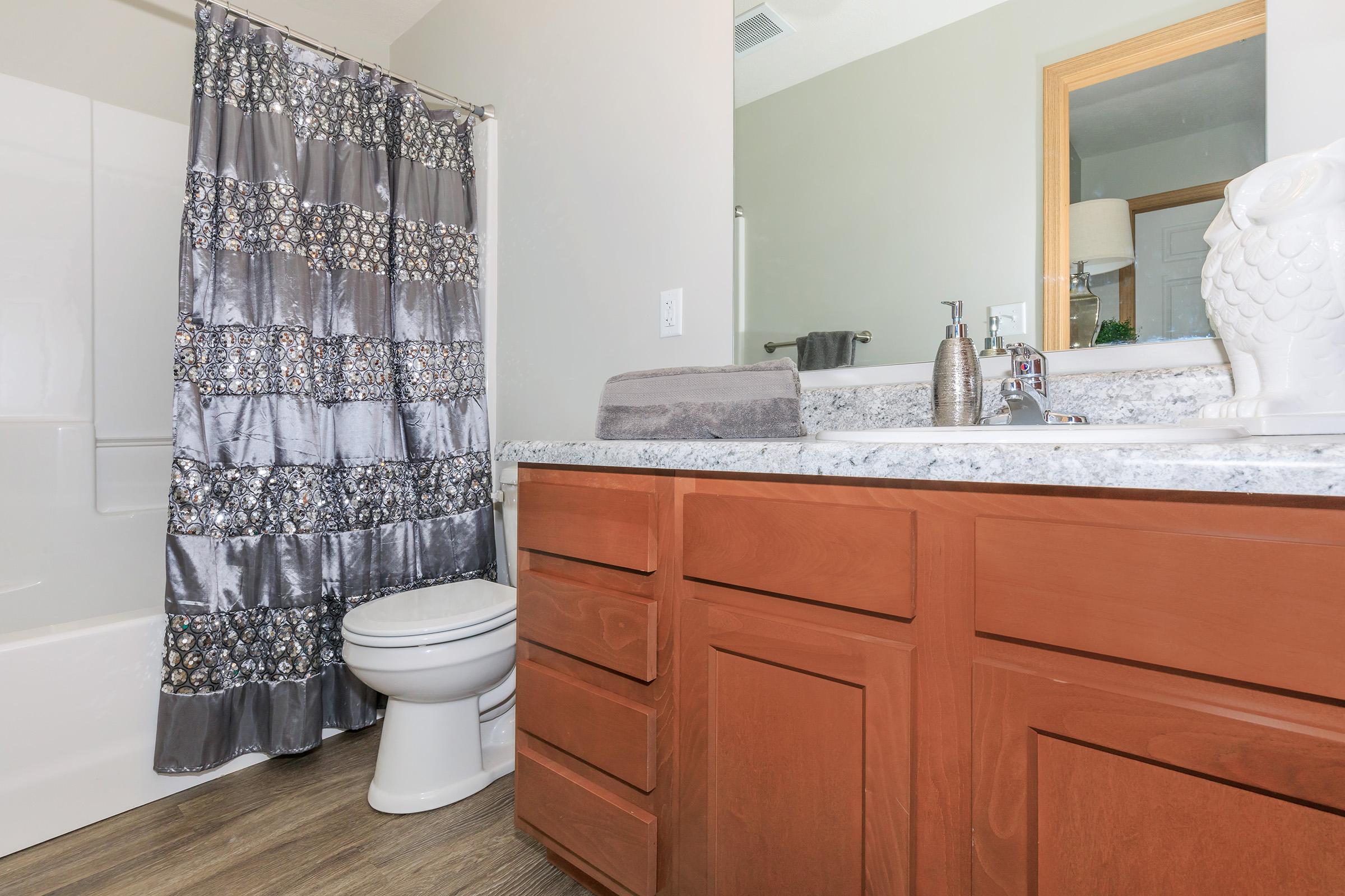 a white sink sitting next to a shower