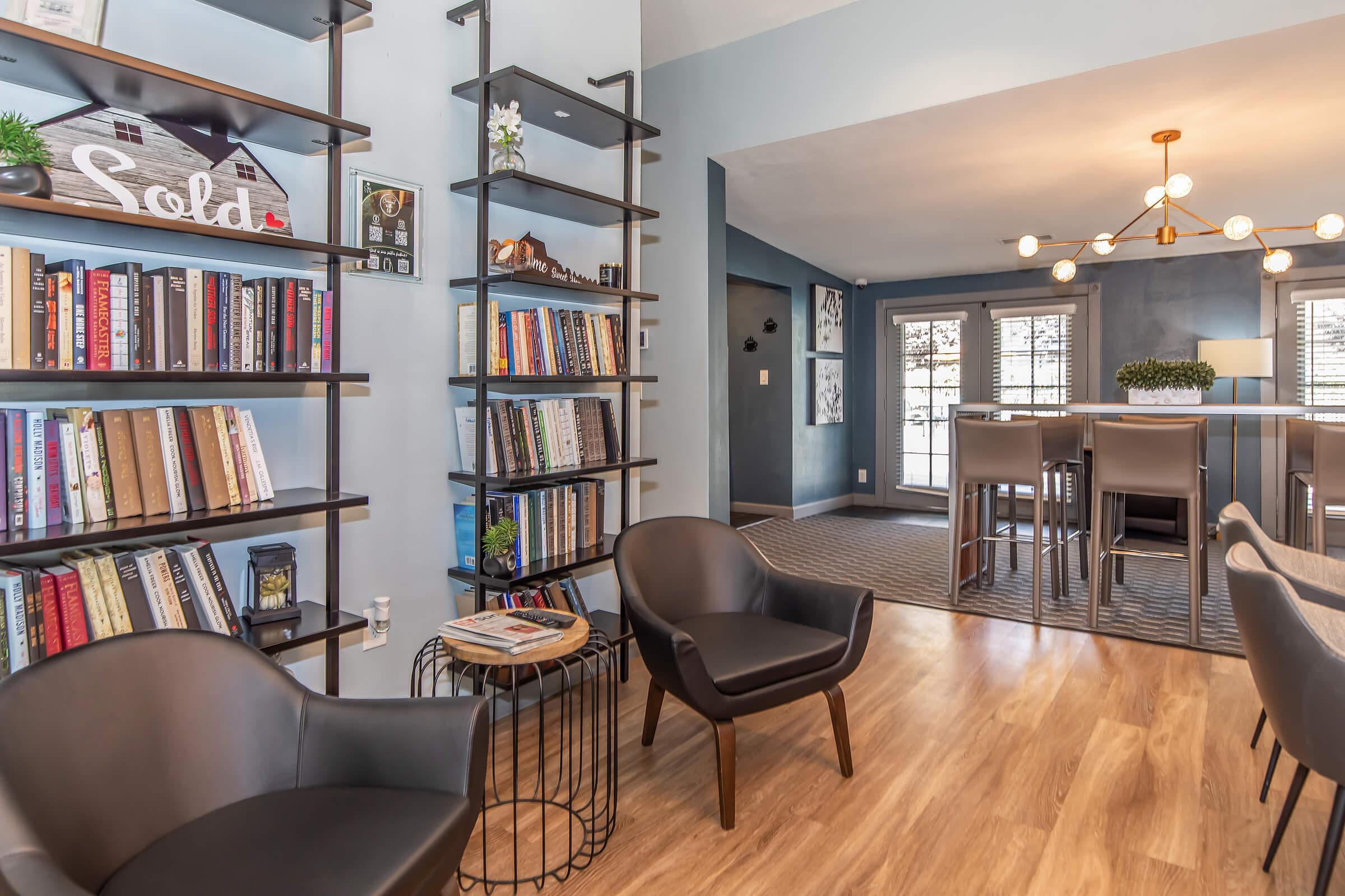 a living room filled with furniture and a book shelf