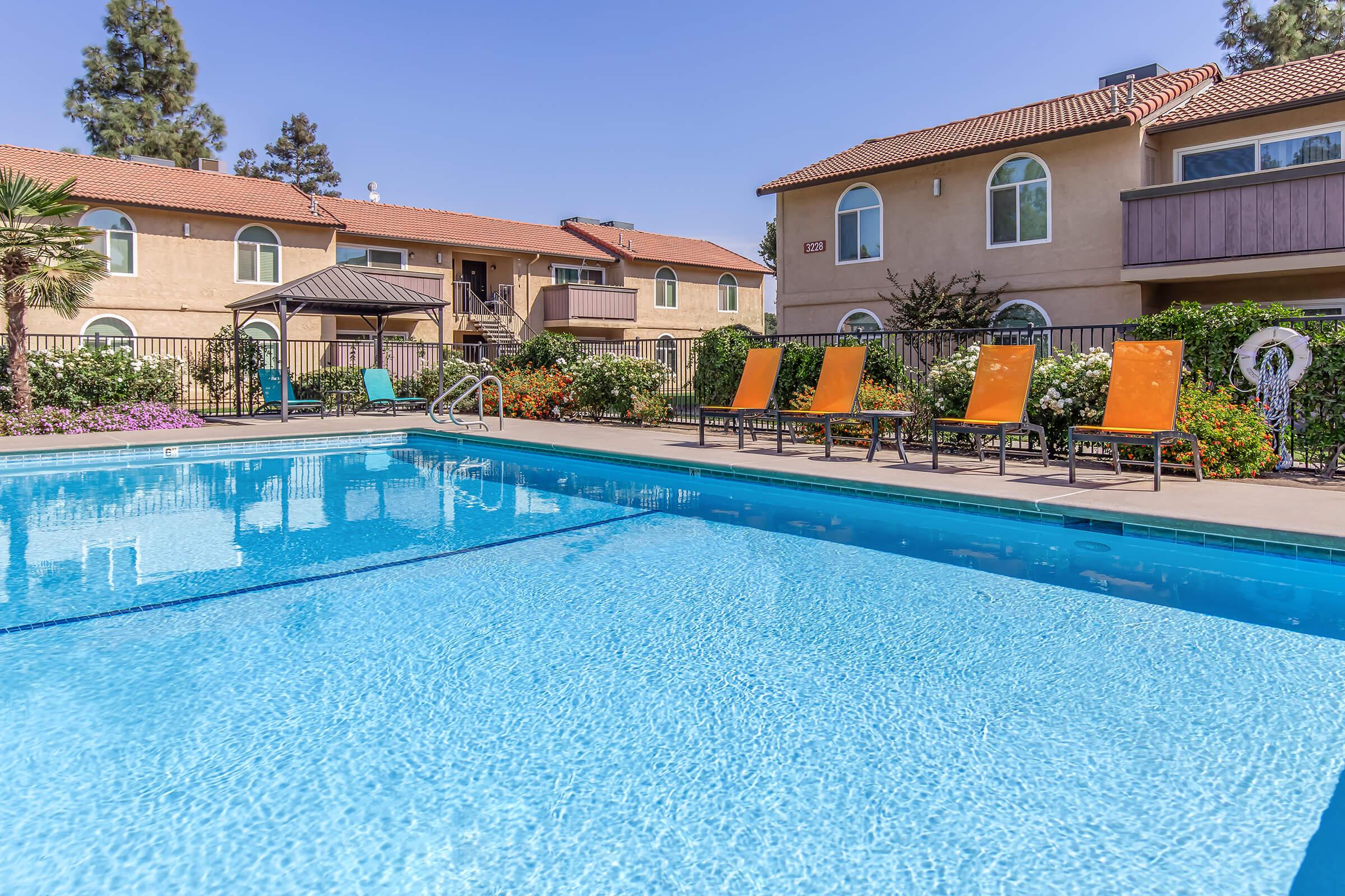 a house with a pool in front of a building