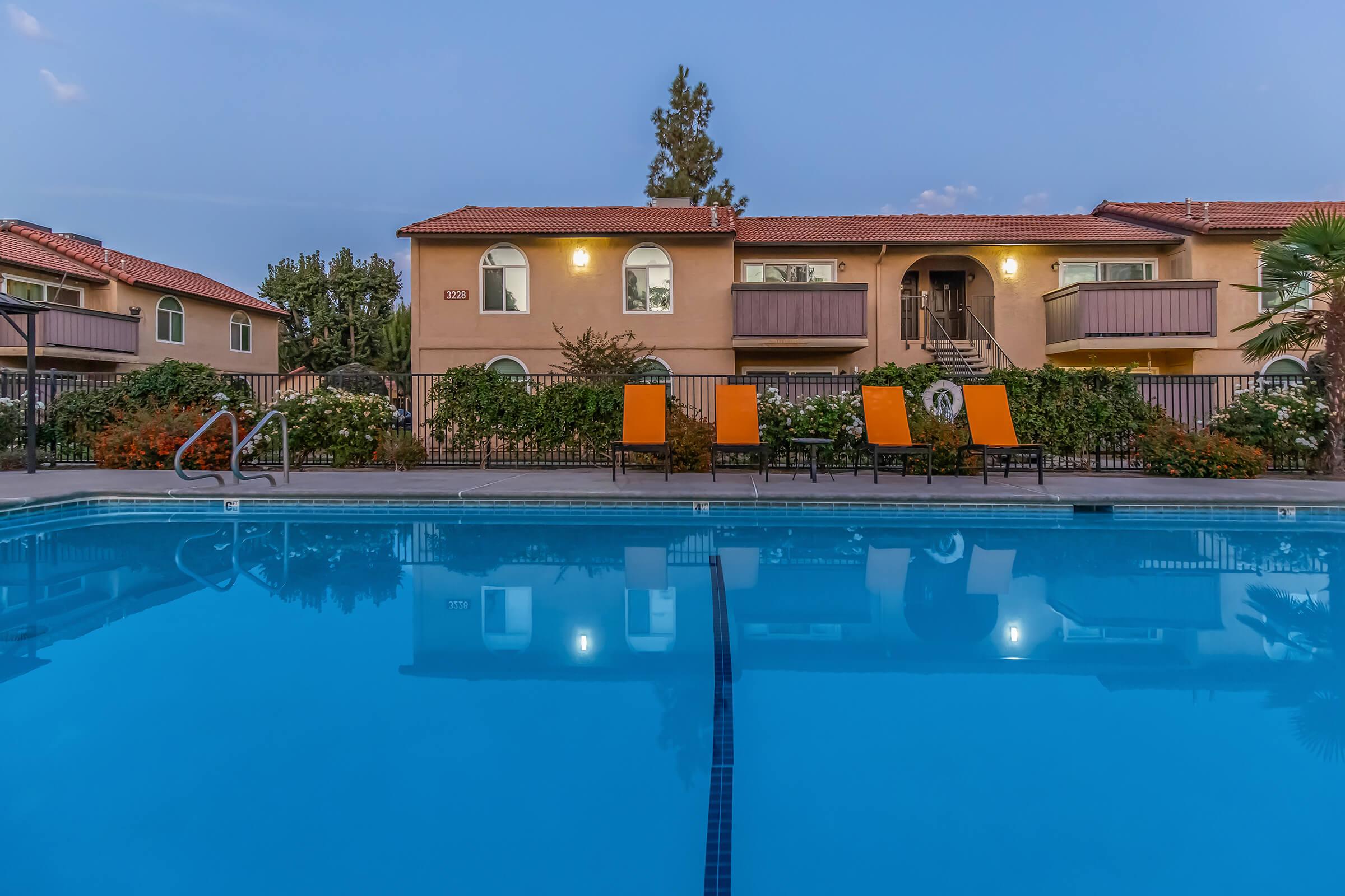 a house with a pool in front of a building