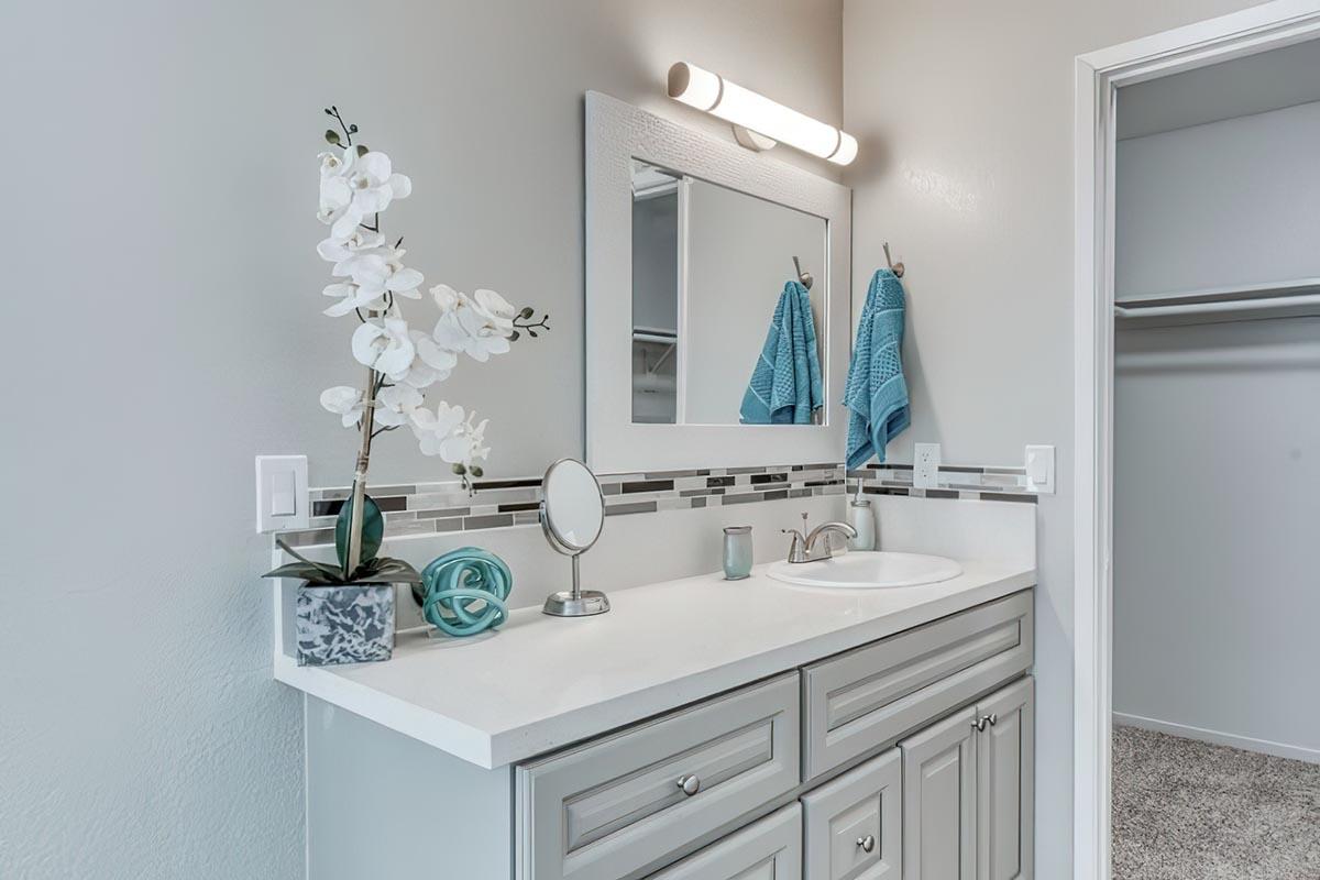 a kitchen with a sink and a mirror