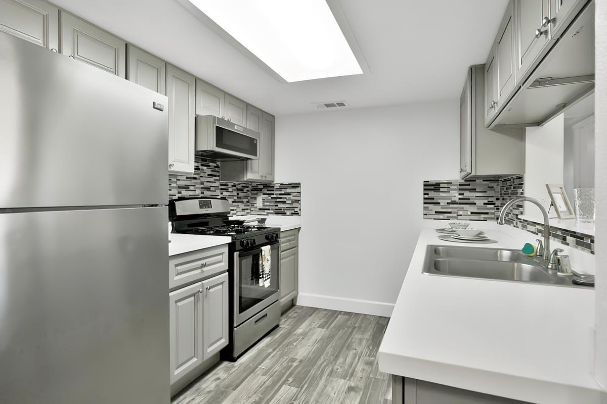 Apartments Near Woodward Park in Visalia, CA - Oak View - Kitchen with Stainless Steel Appliances, Granite-Style Countertops, and Plenty of Cabinet Space