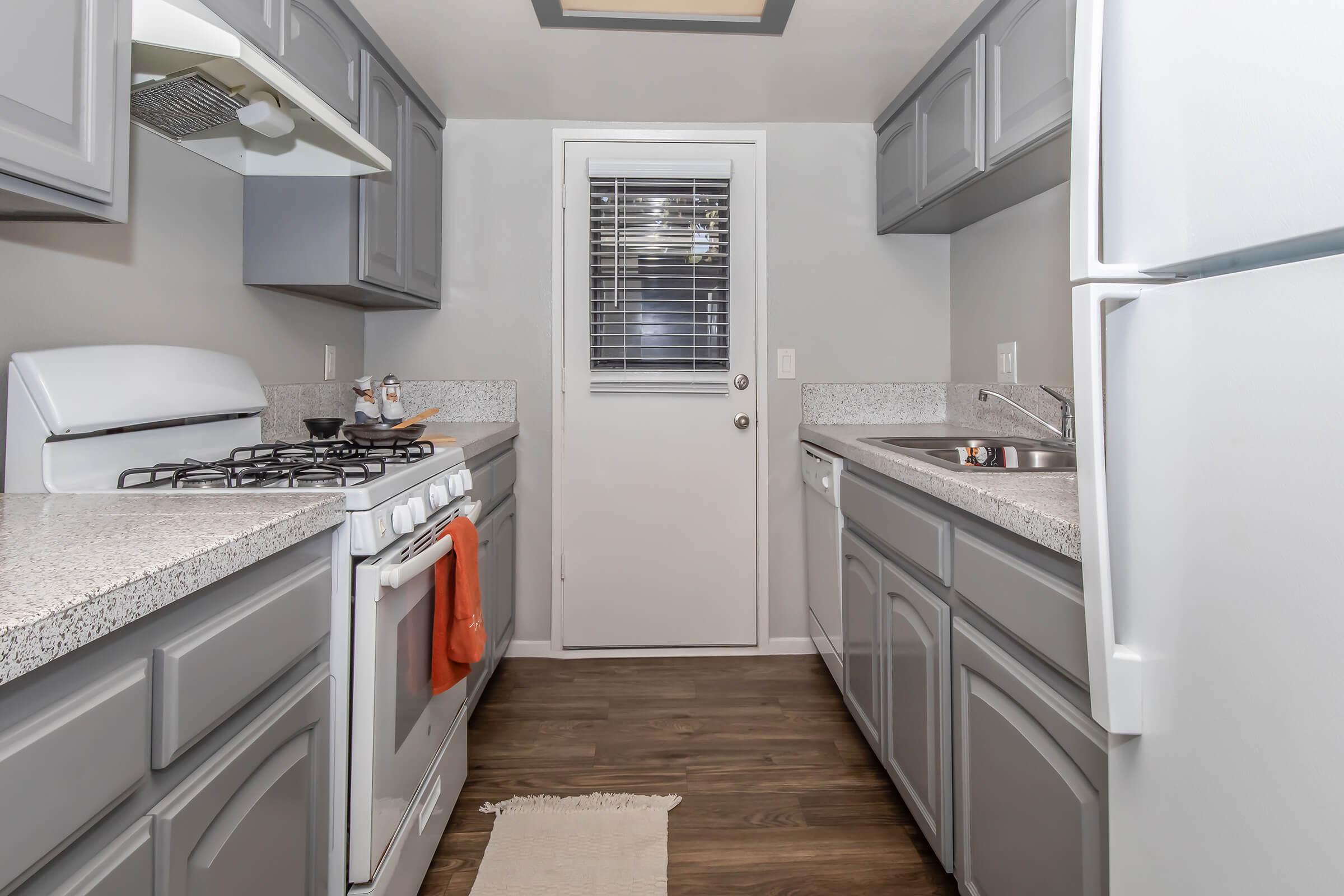 a kitchen with a stove sink and refrigerator