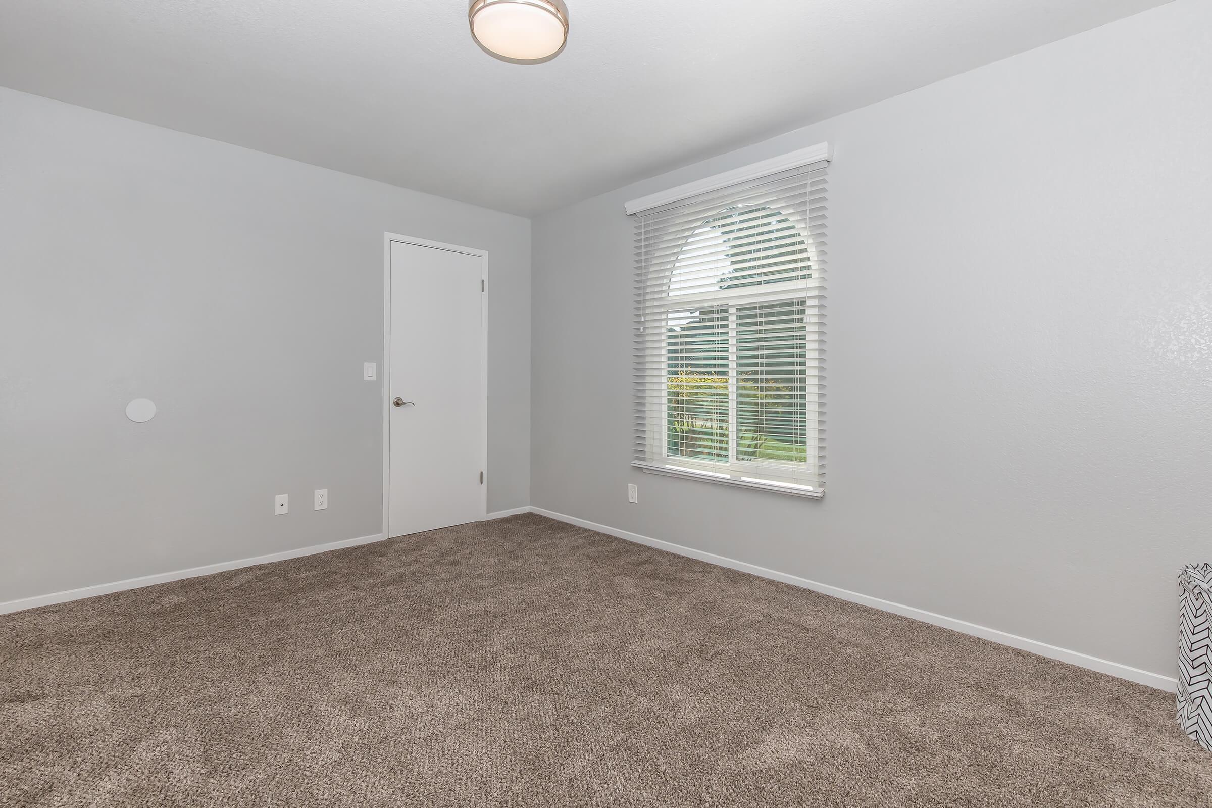 a bedroom with a large window