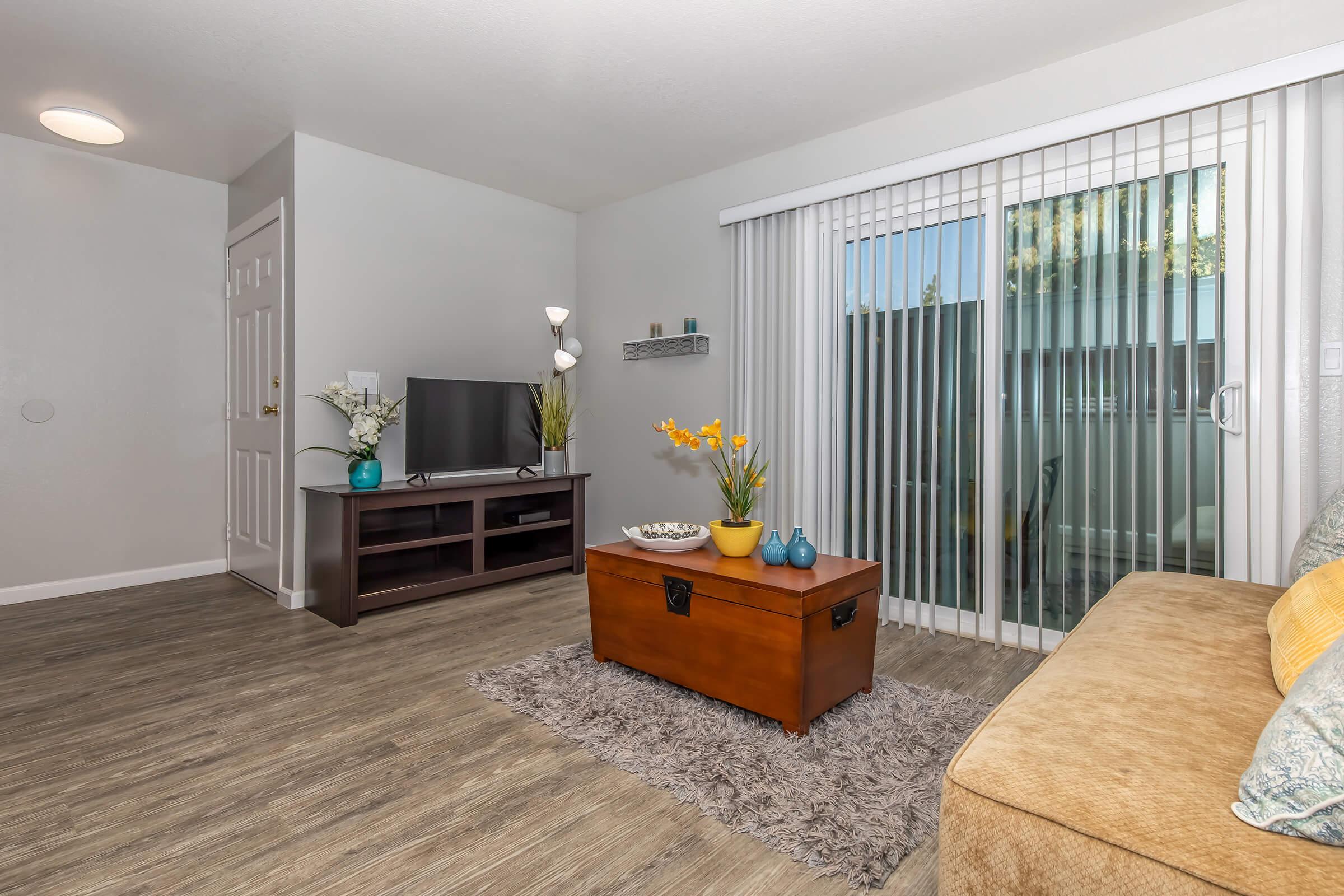 a living room filled with furniture and a flat screen tv