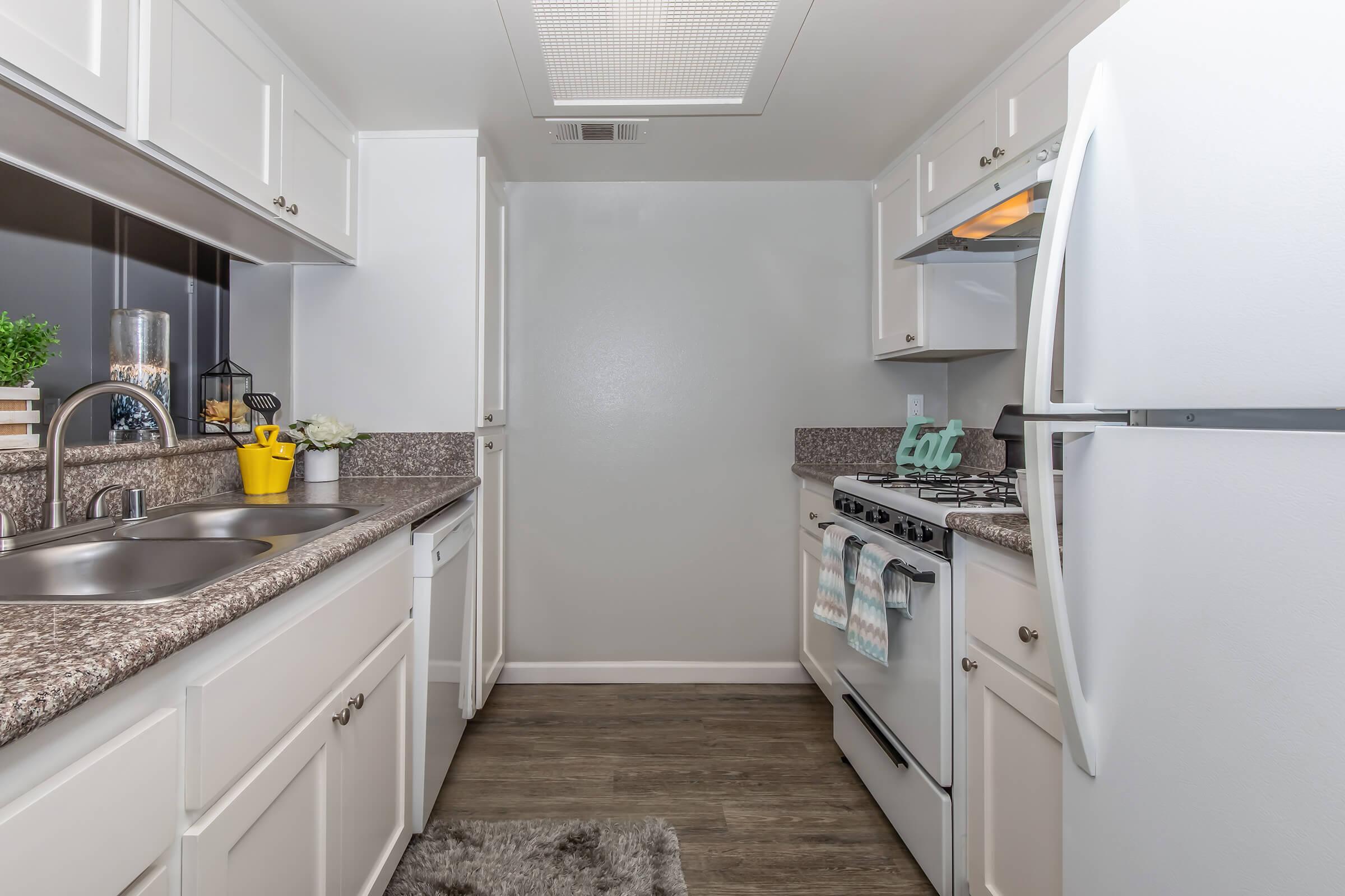 a kitchen with a sink and a refrigerator