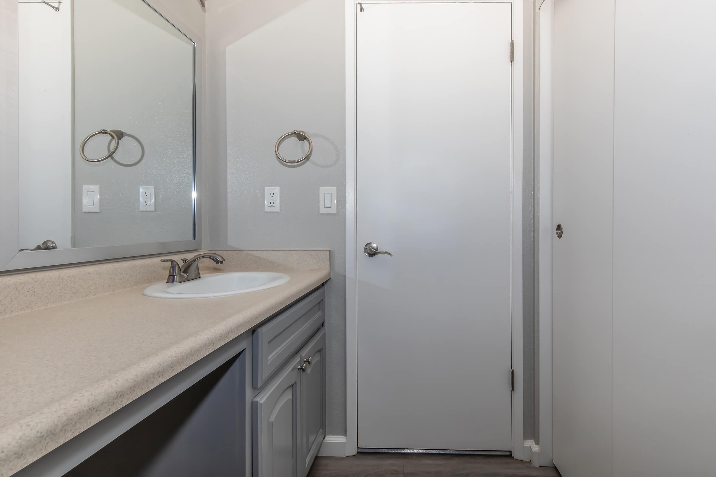 a kitchen with a sink and a mirror