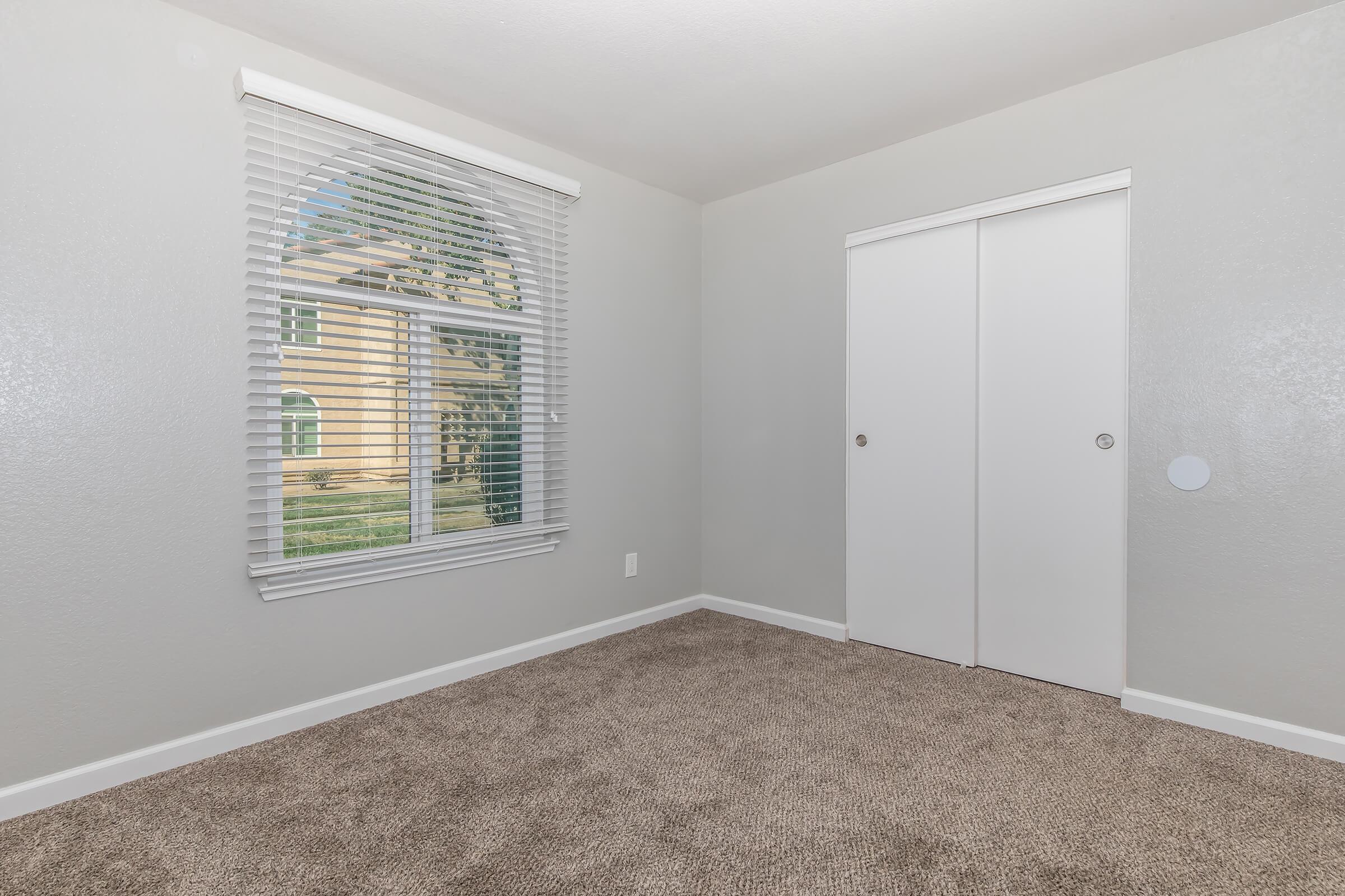 a bedroom with a large window