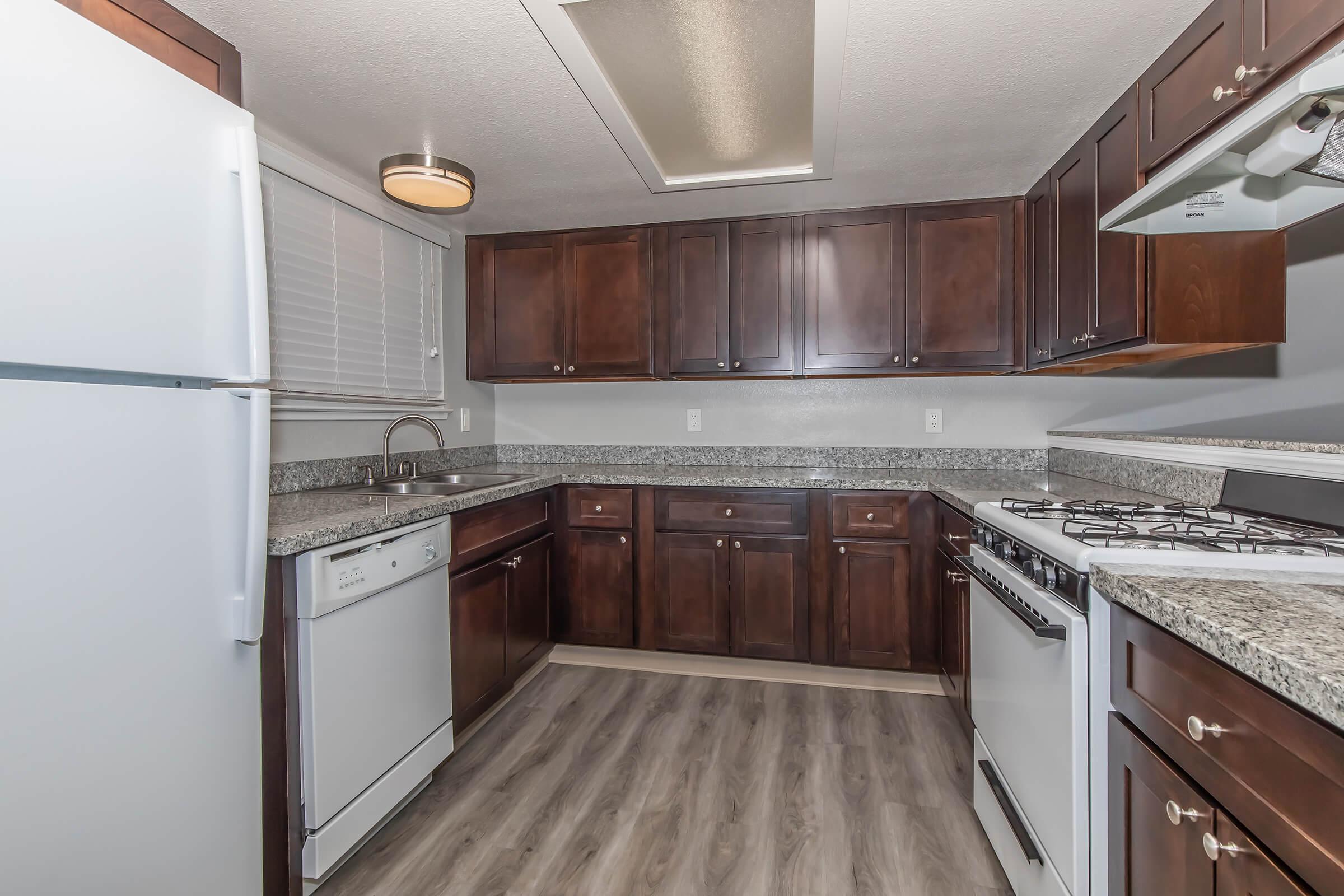 a kitchen with stainless steel appliances and wooden cabinets