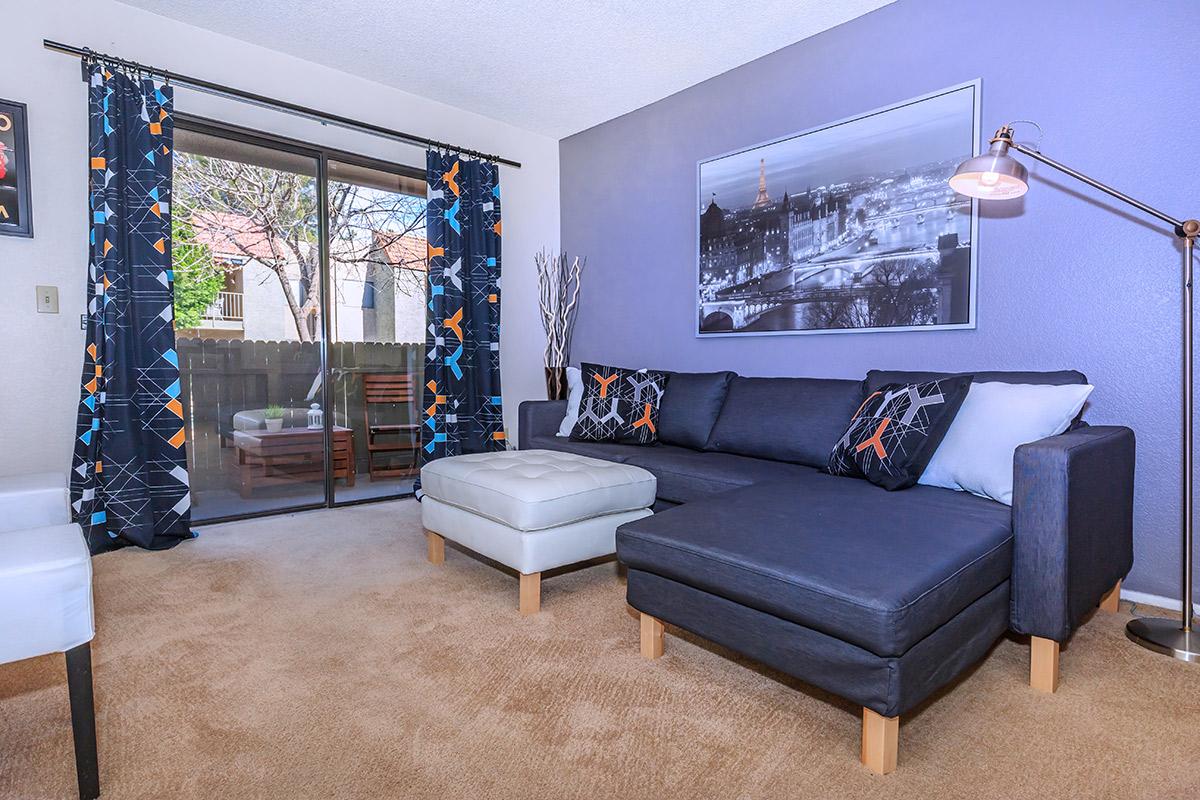 a living room filled with furniture and a flat screen tv