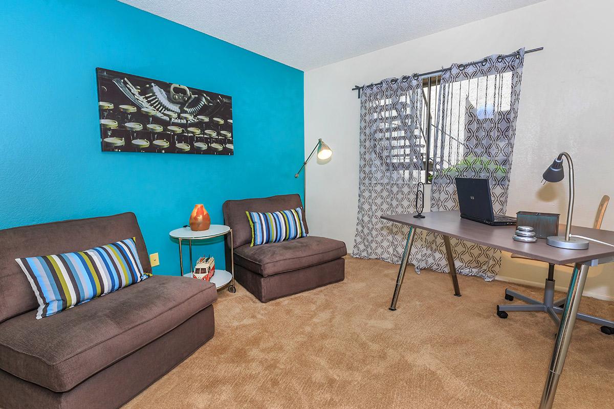 a living room filled with furniture and a rug