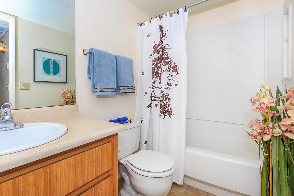 a white tub sitting next to a sink