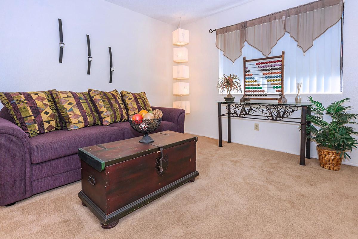 a living room filled with furniture and a tv