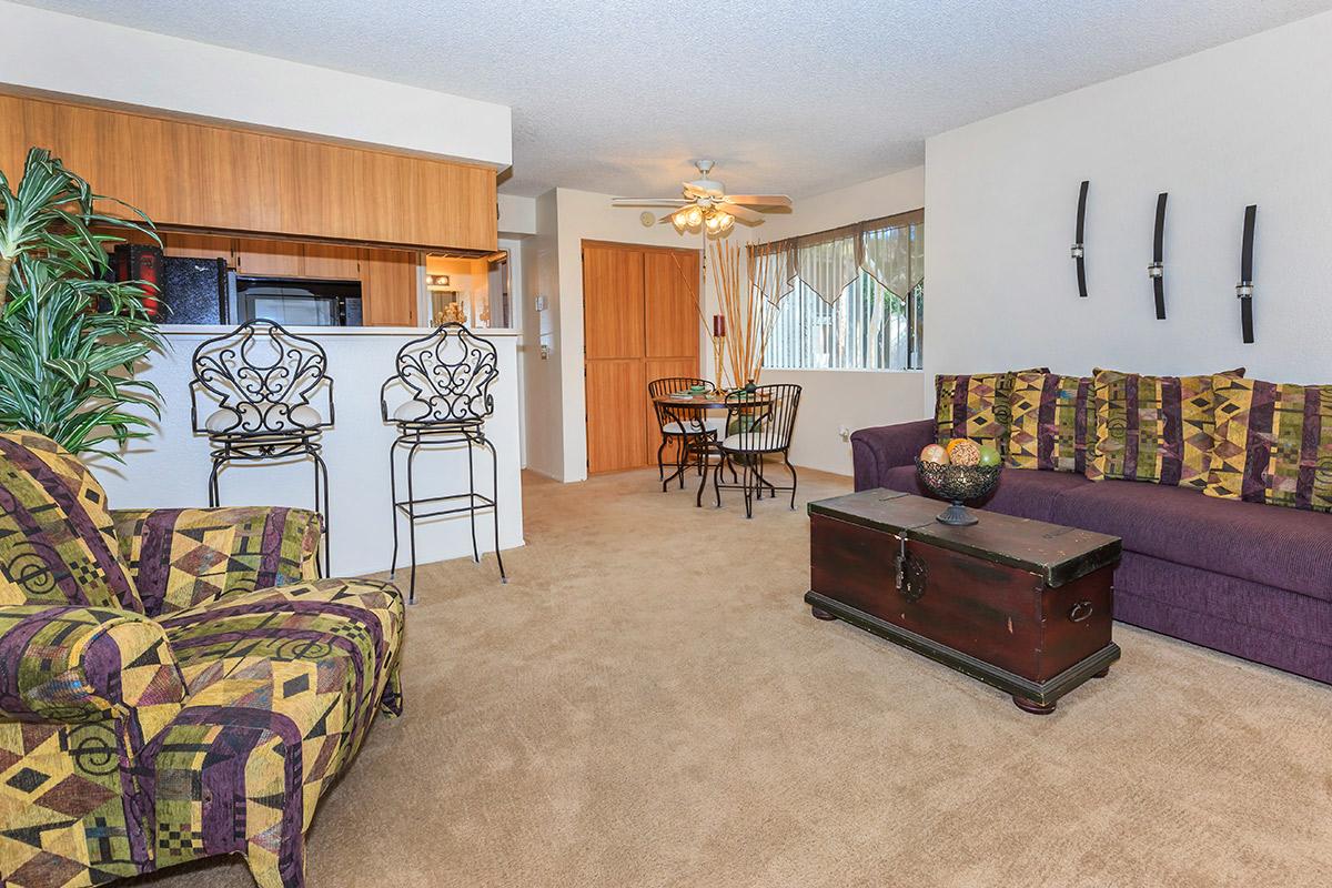 a living room filled with furniture and a bed