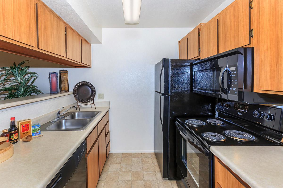 a modern kitchen with stainless steel appliances and wooden cabinets