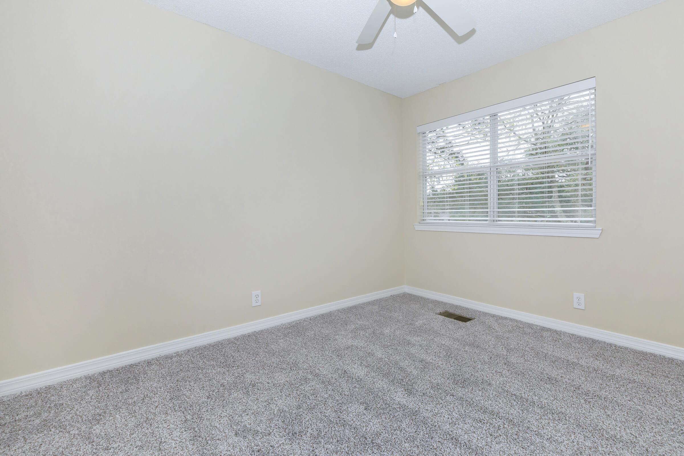 a bedroom with a large window