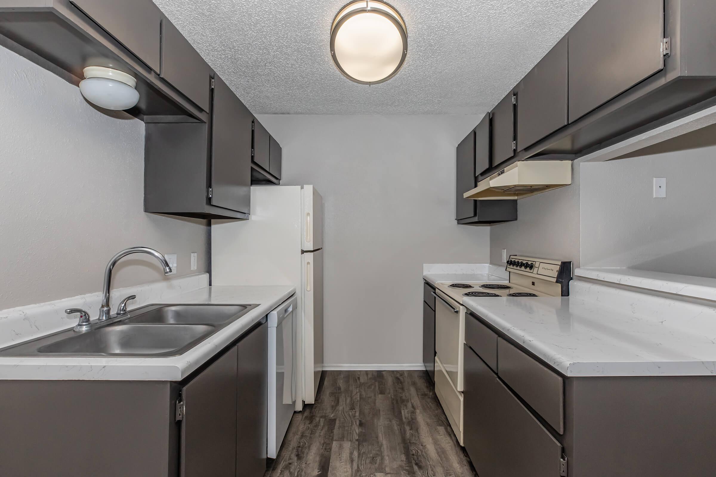 a kitchen with a sink and a mirror