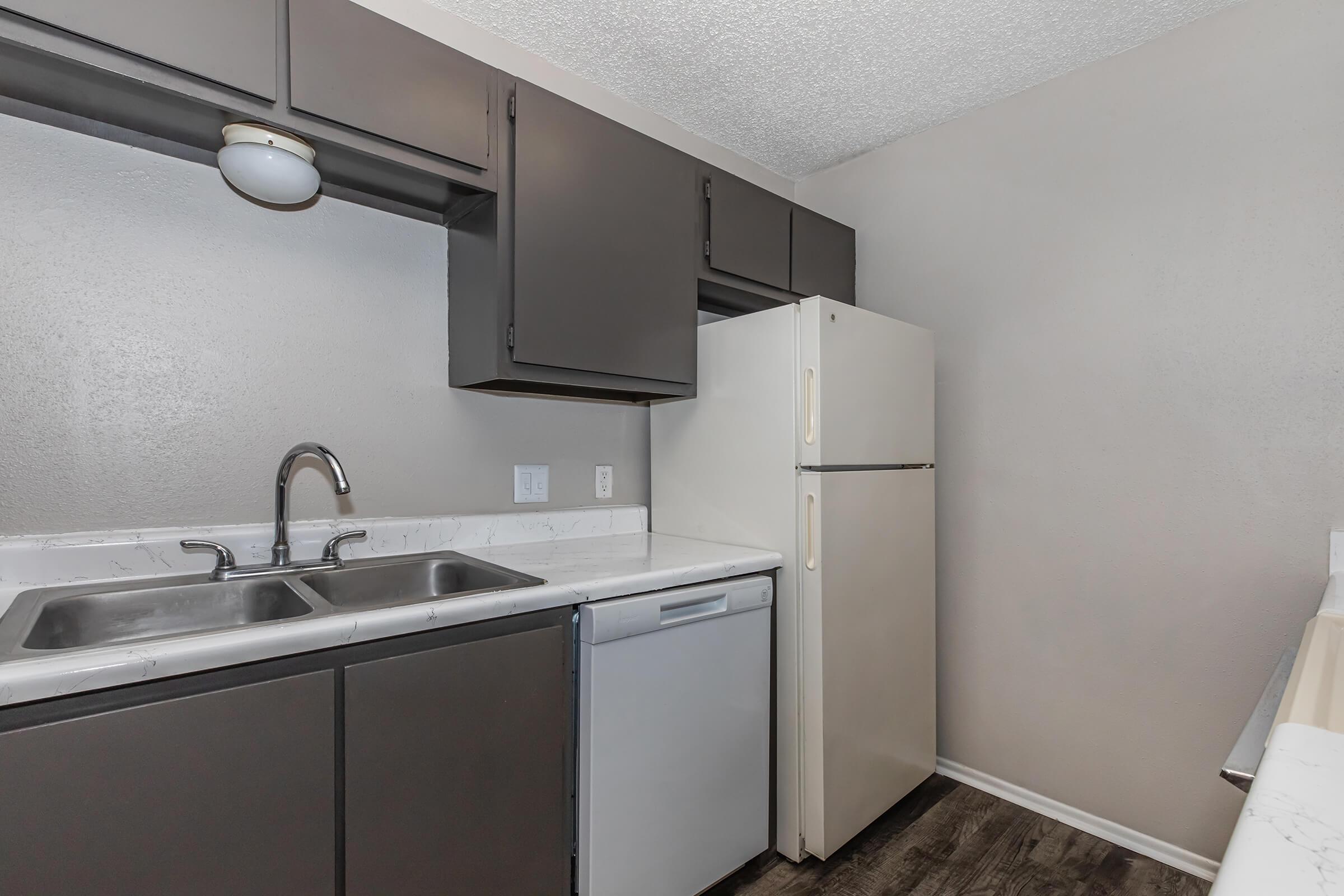 a kitchen with a sink and a refrigerator