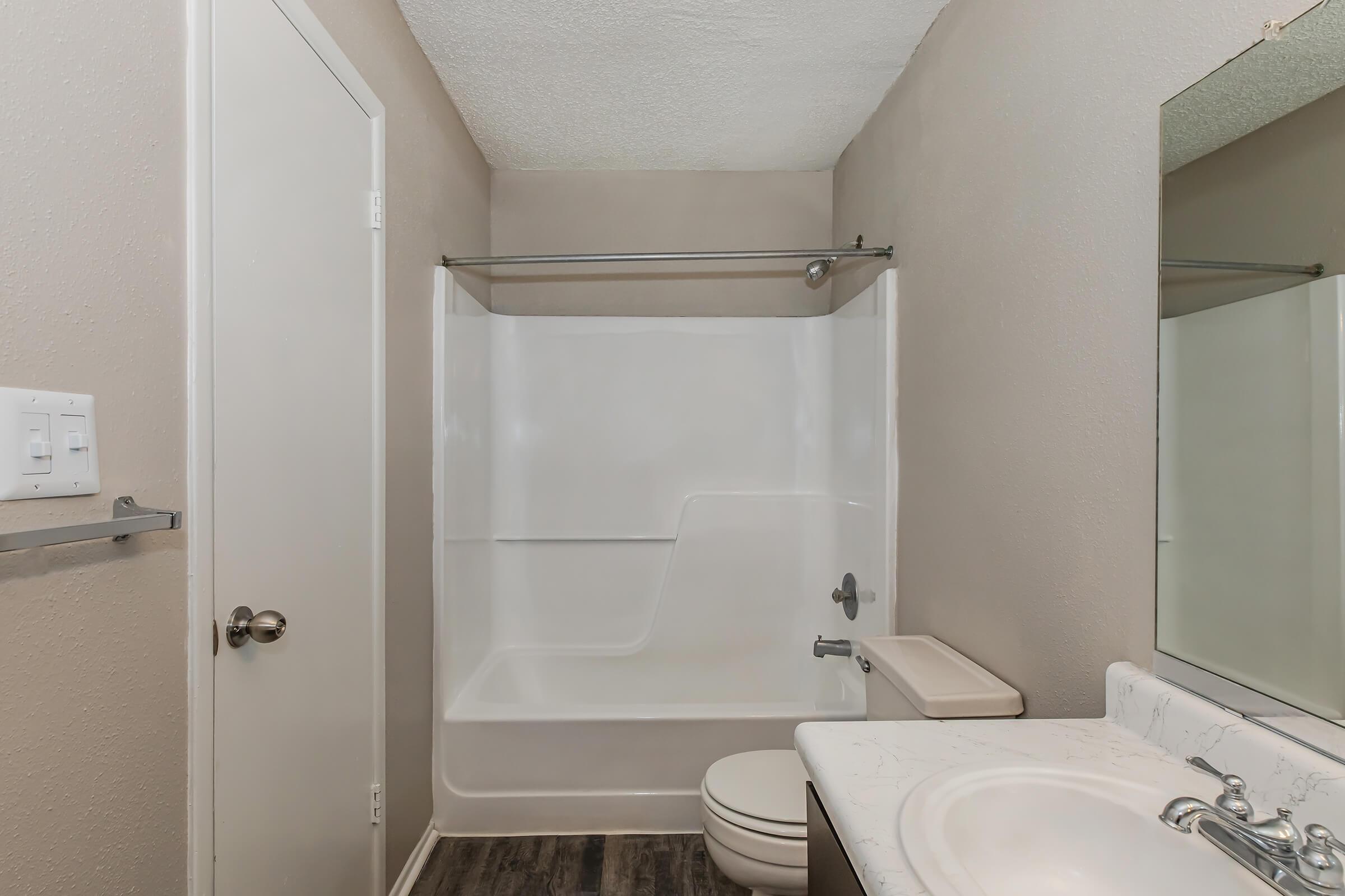 a shower that has a sink and a mirror