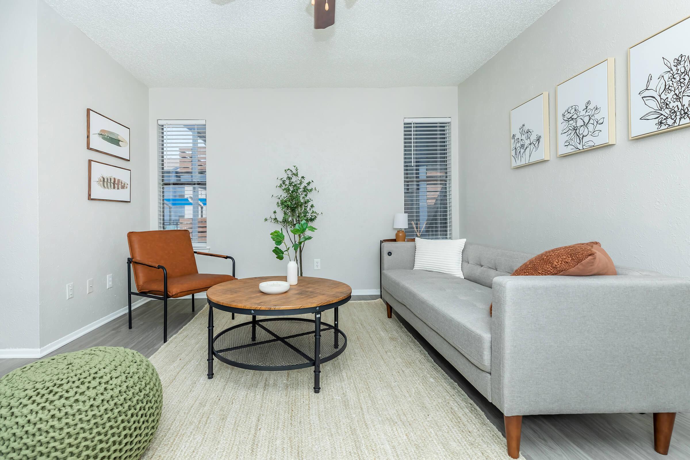 a living room filled with furniture and a large window