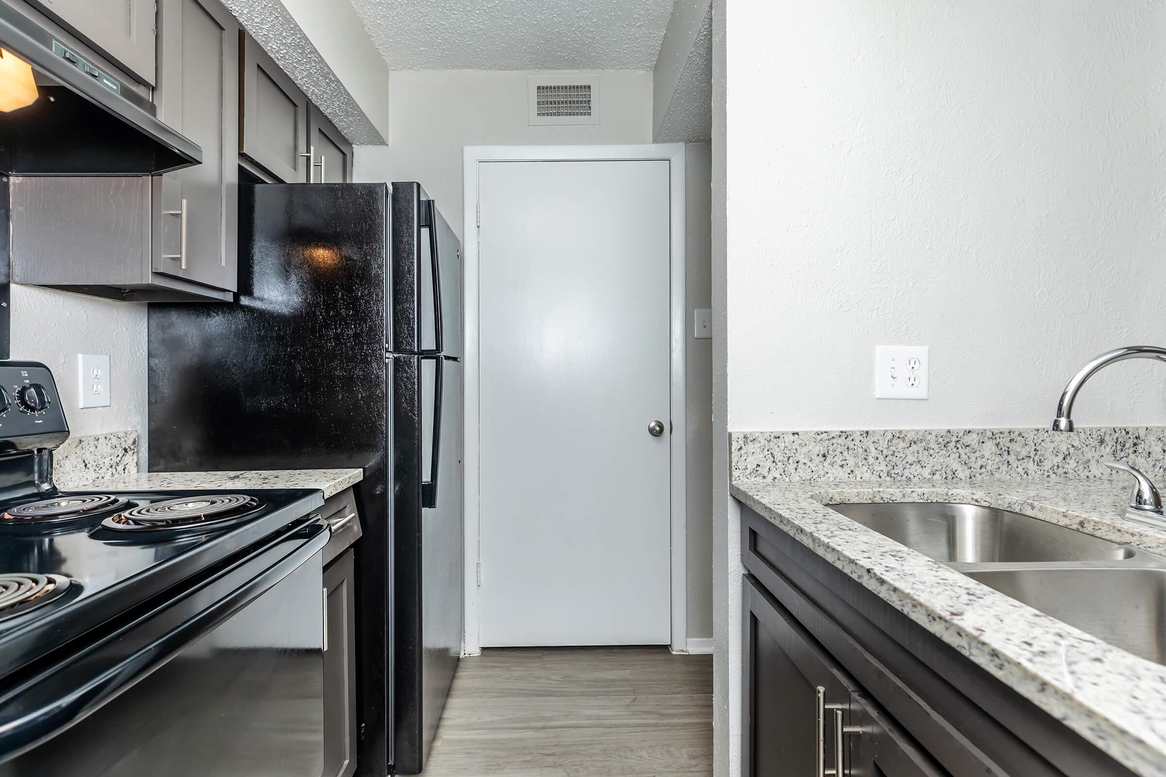 a kitchen with a stove top oven sitting inside of a building