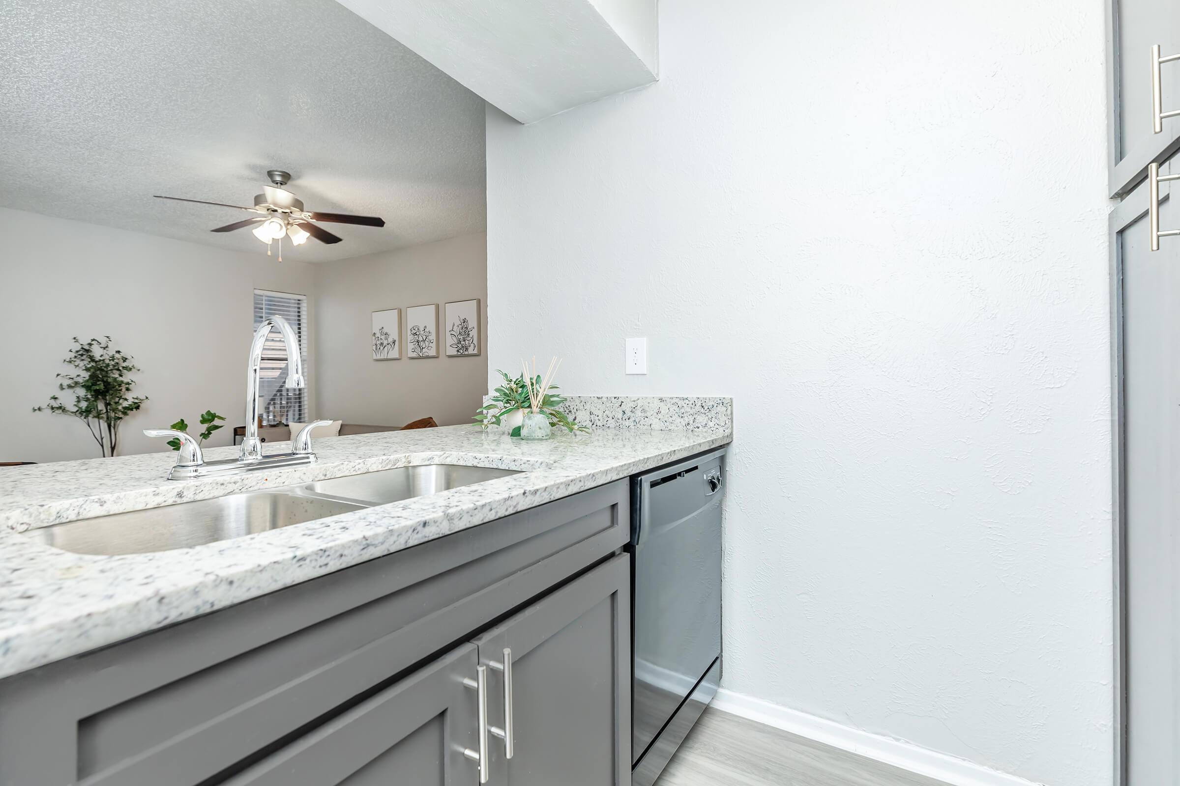 a kitchen with a sink and a mirror