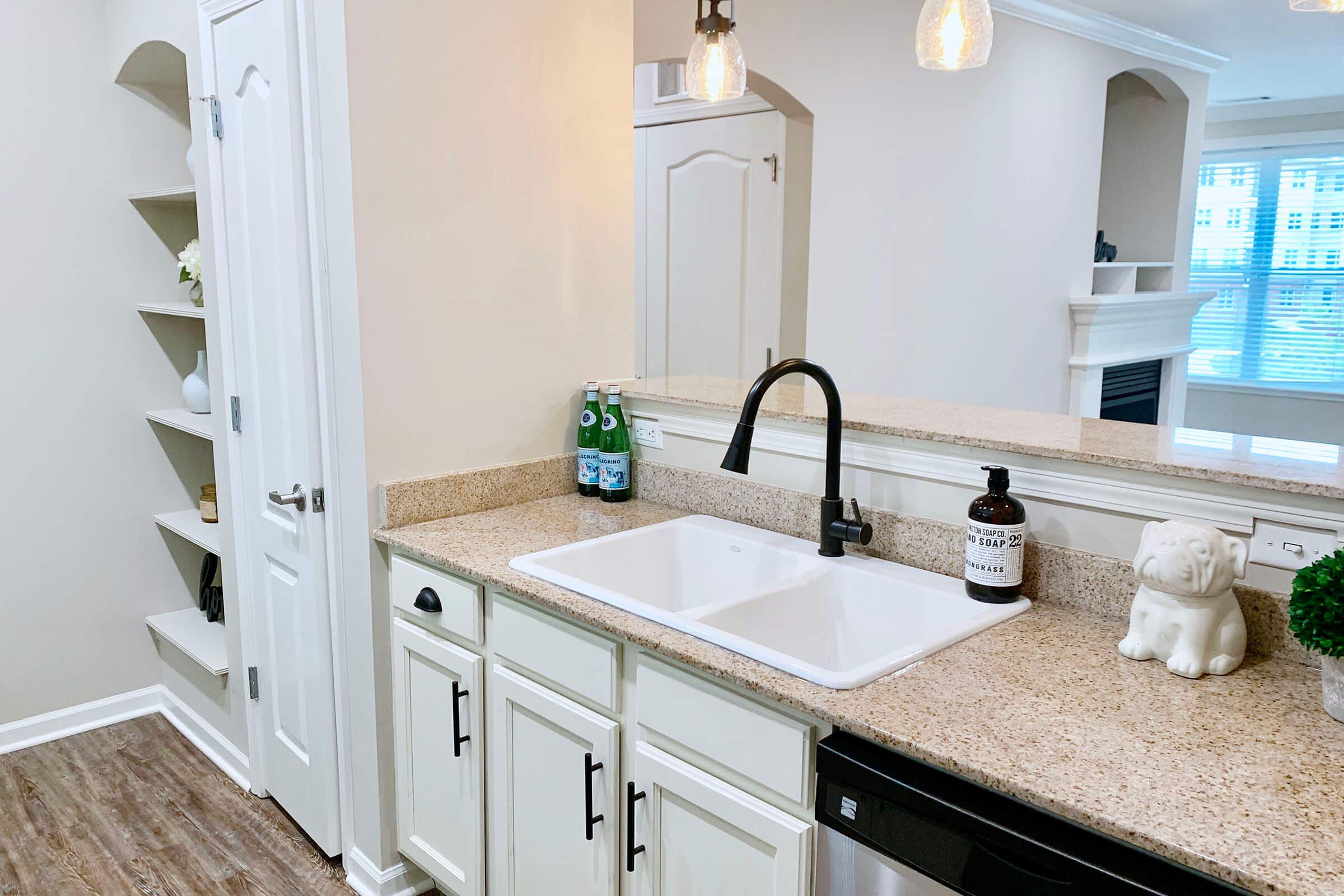 a kitchen with a sink and a mirror