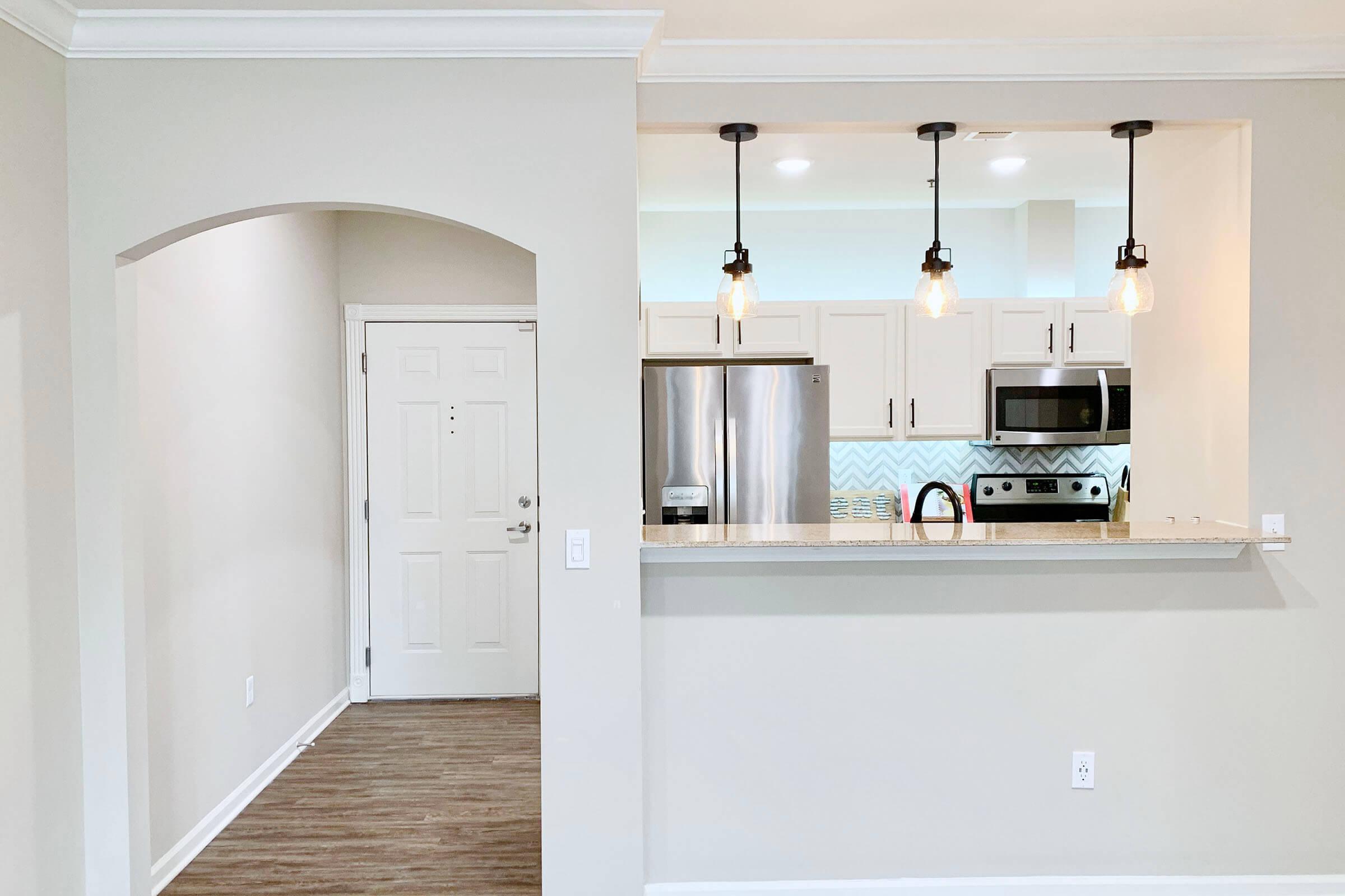 a kitchen with a sink and a refrigerator