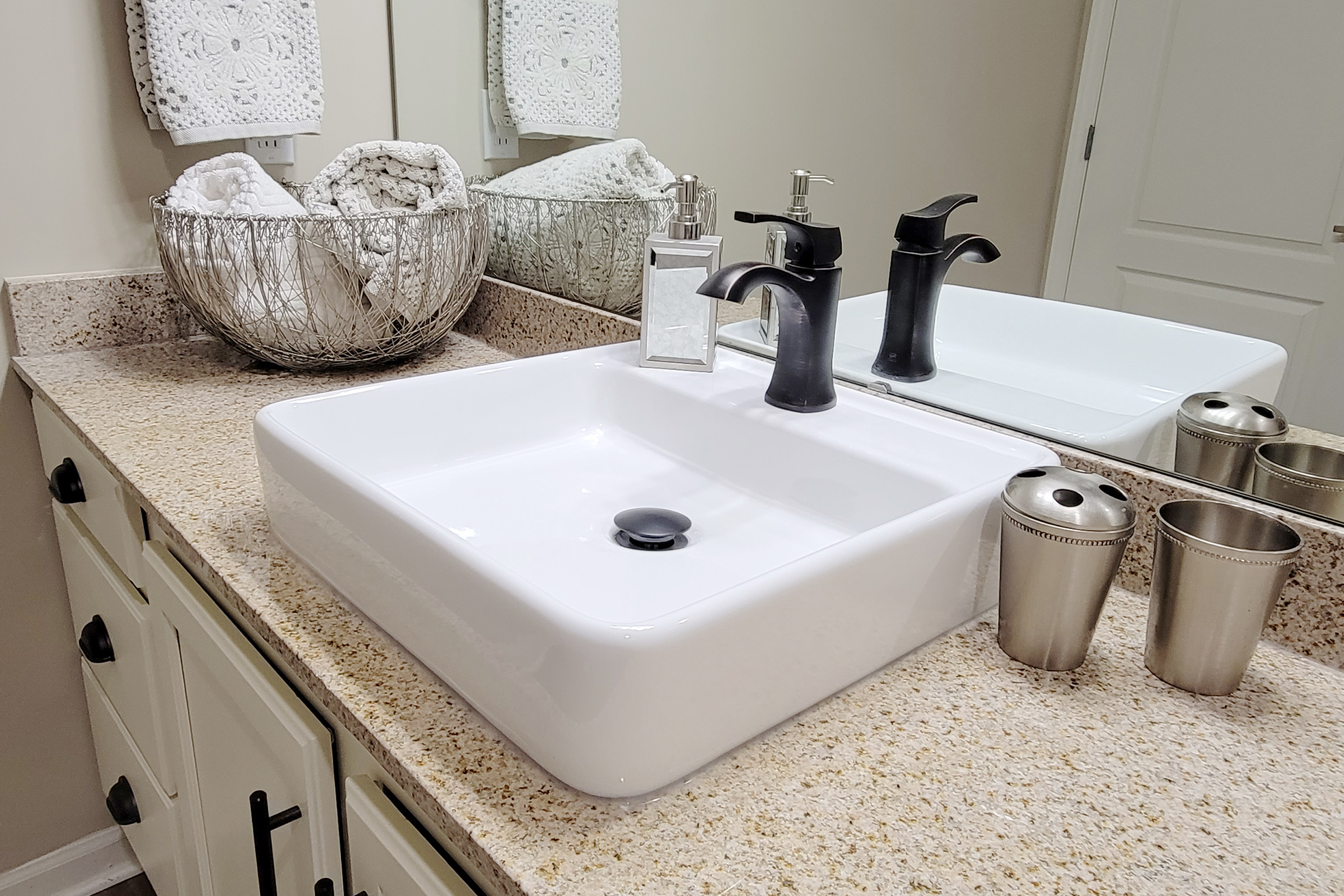 a close up of a sink and a mirror