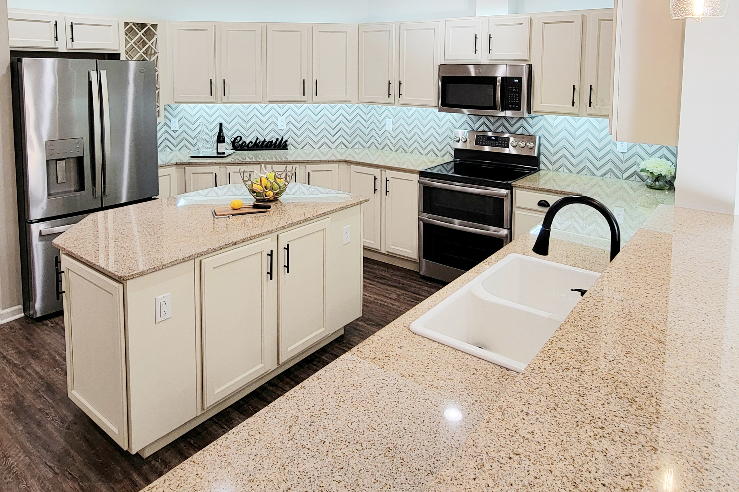 a kitchen with a sink and a mirror