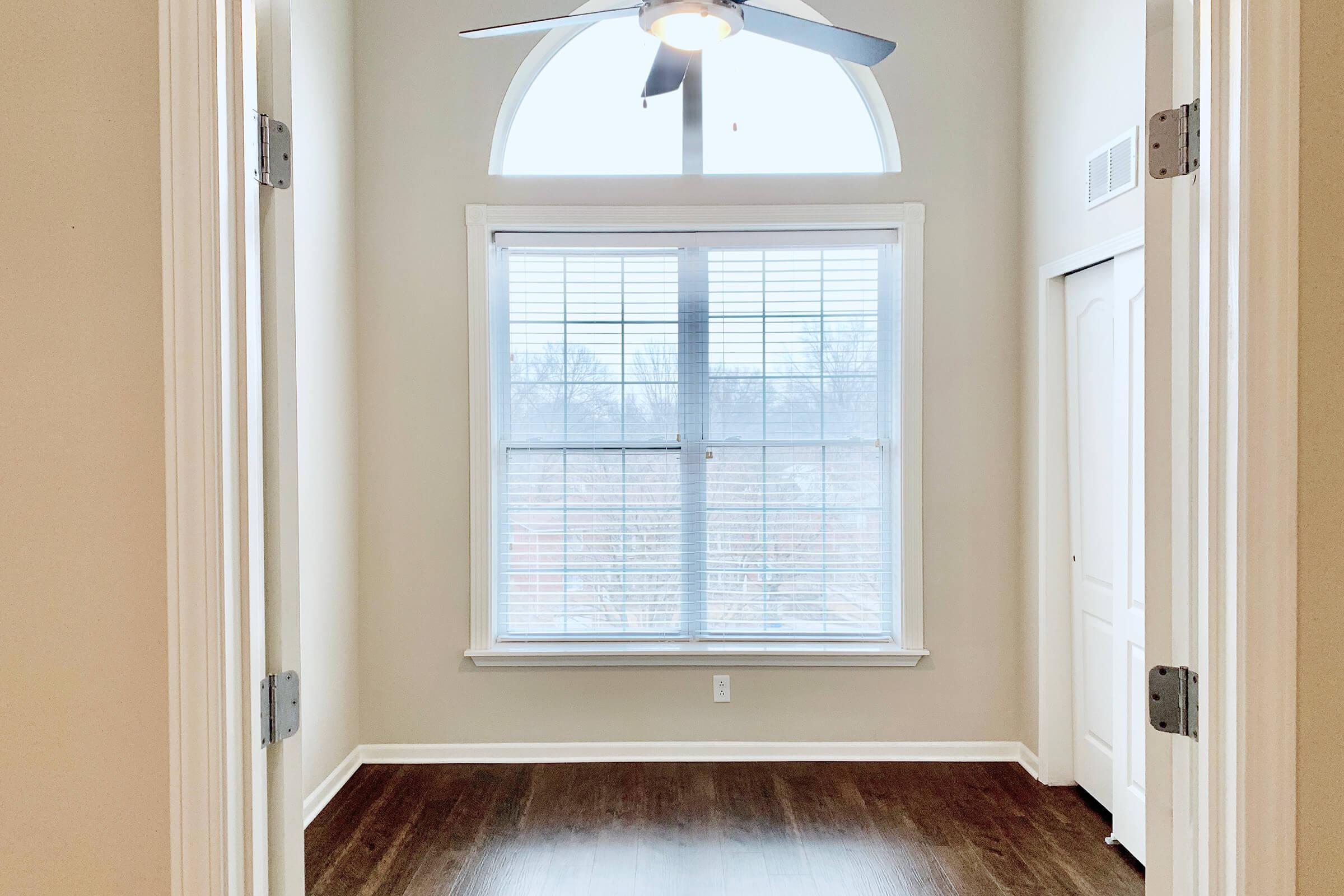 a bedroom with a large window