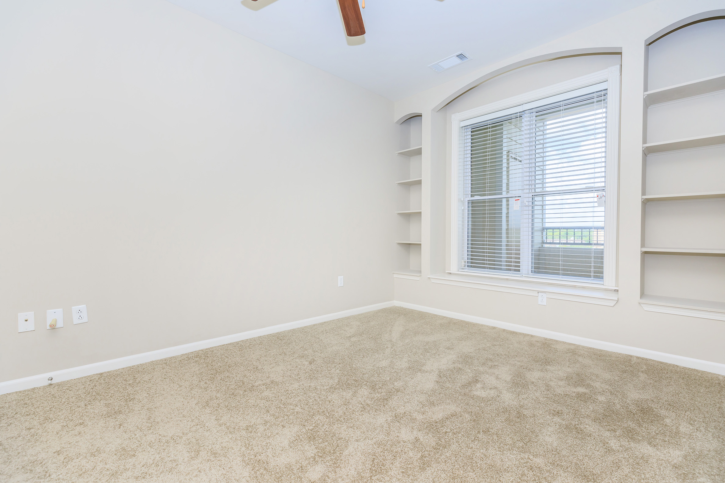 a bedroom with a large window