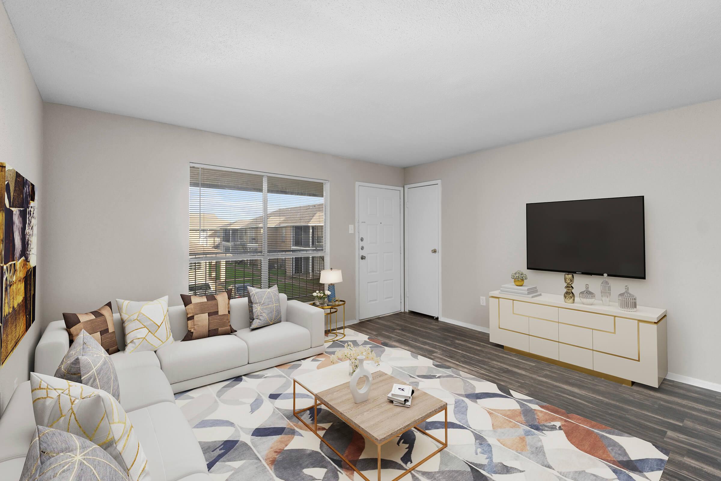 a living room filled with furniture and a bed