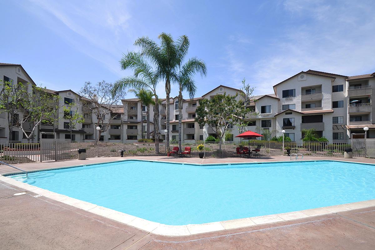 a house with a pool in front of a building