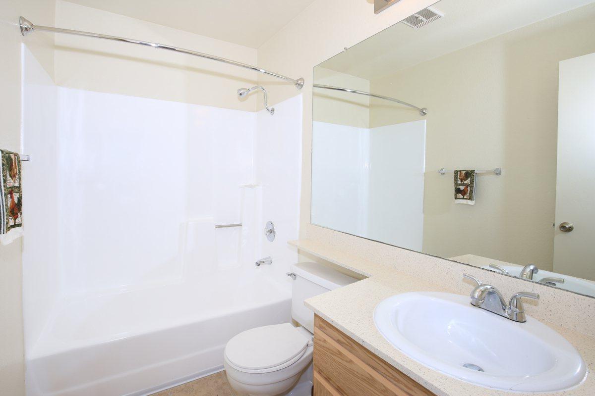 a large white tub next to a sink