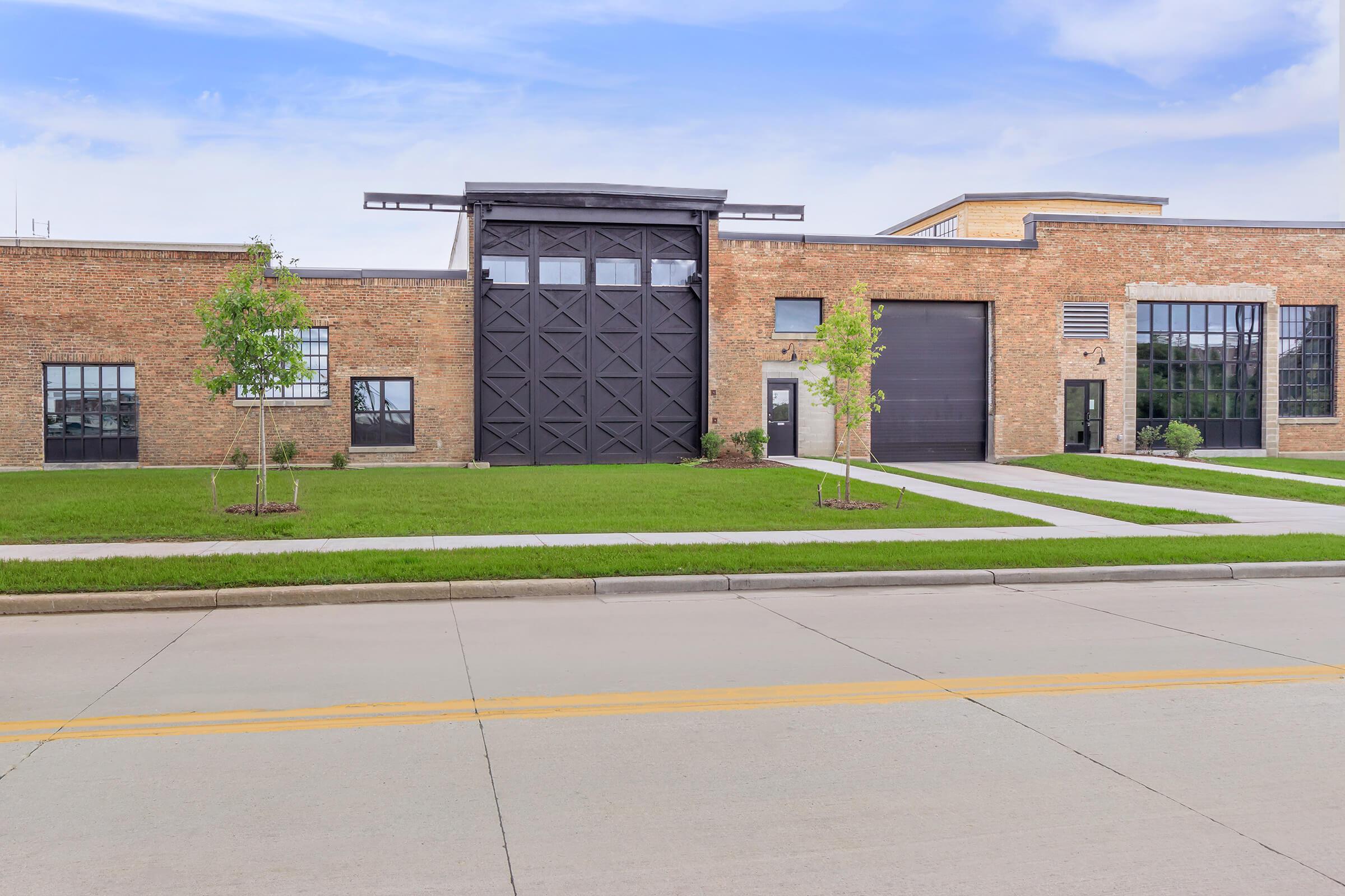 an empty road in front of a brick building