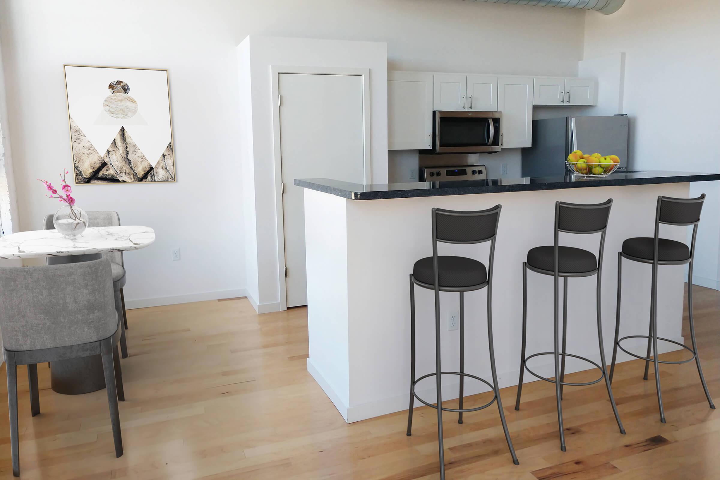 a kitchen with a table and a chair in a room