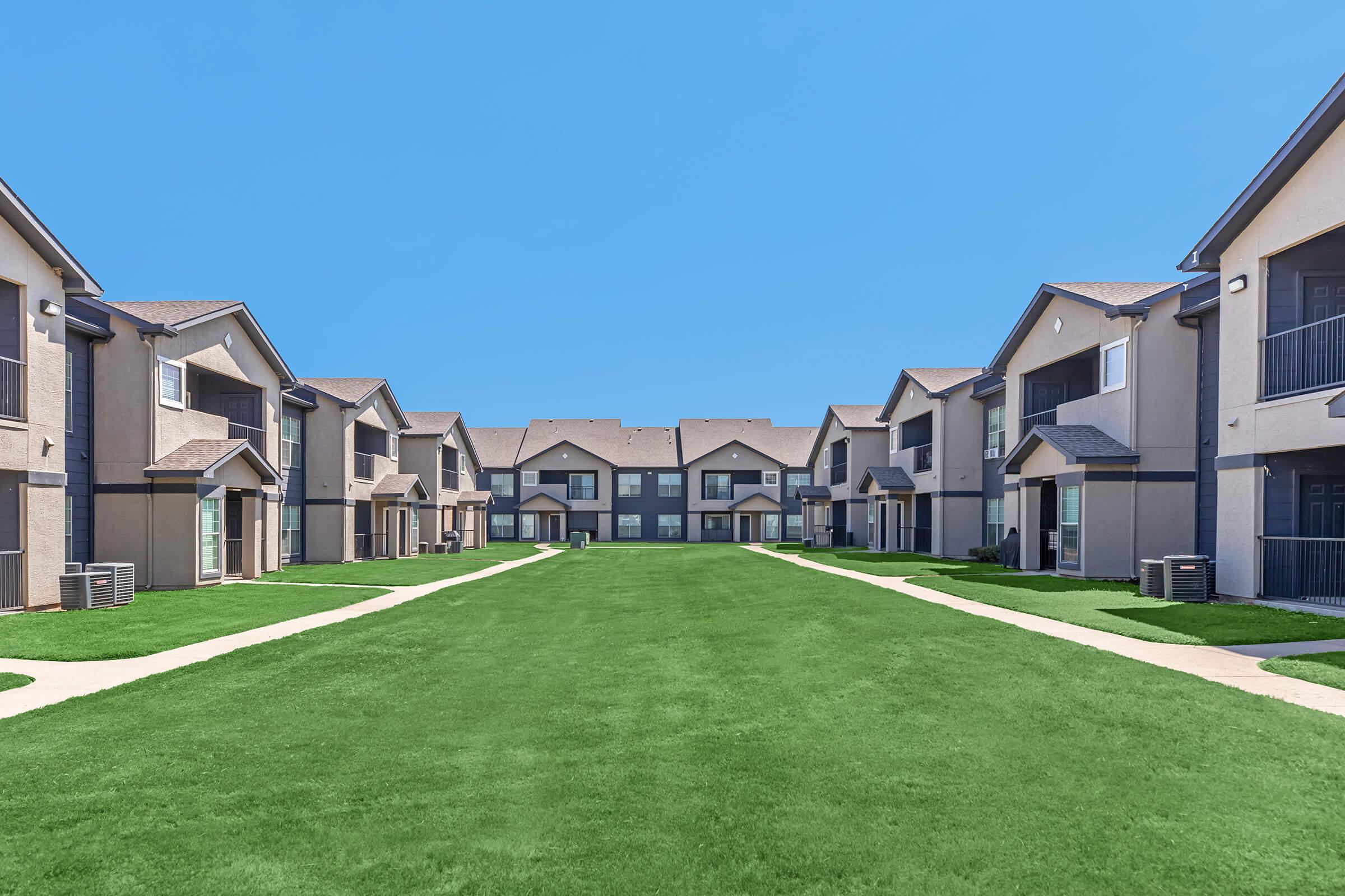 a house with a lawn in front of a building