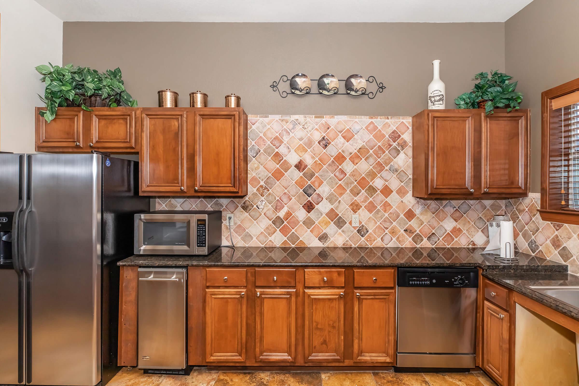 a kitchen with stainless steel appliances and wooden cabinets