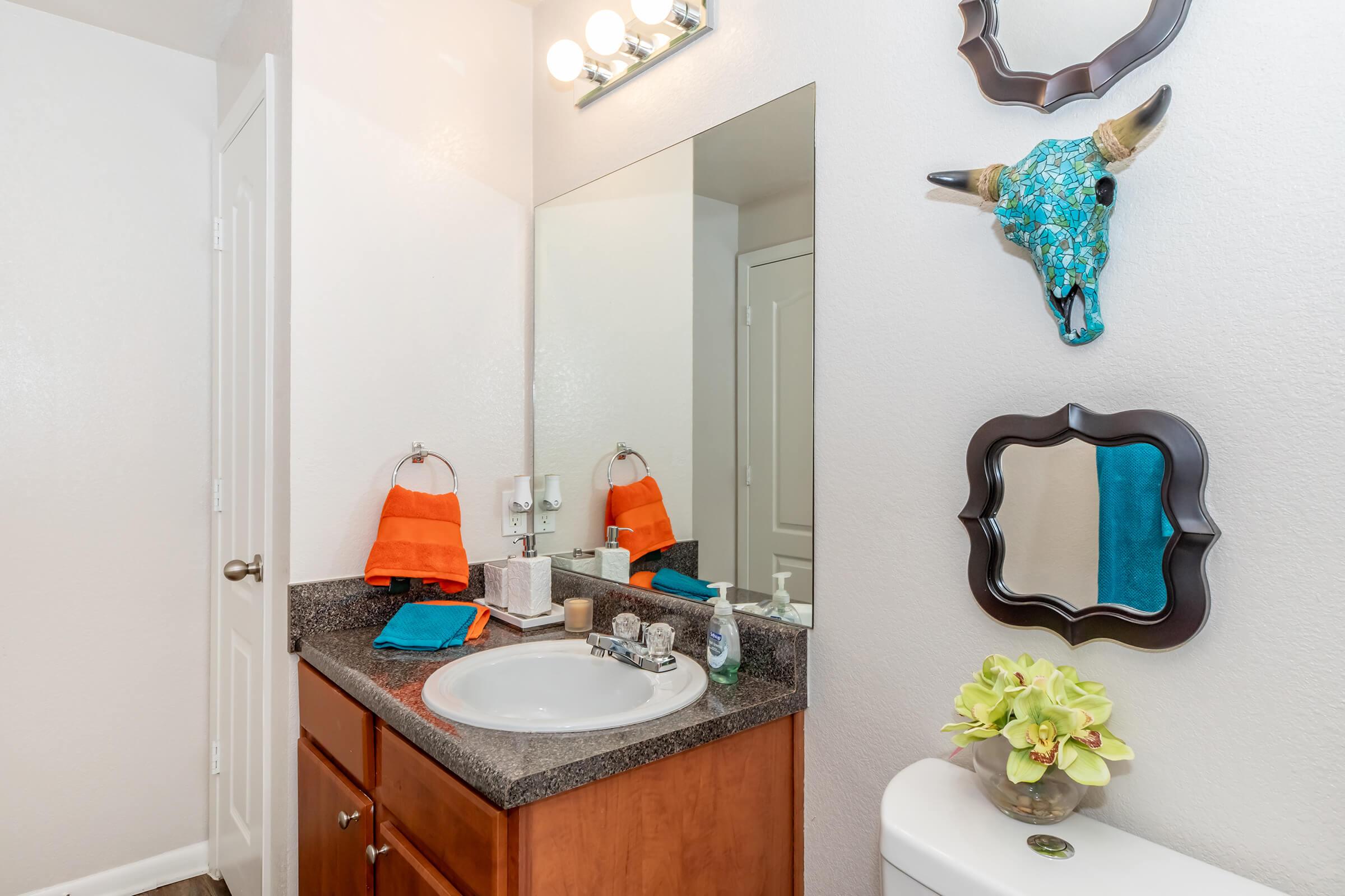 a kitchen with a sink and a mirror