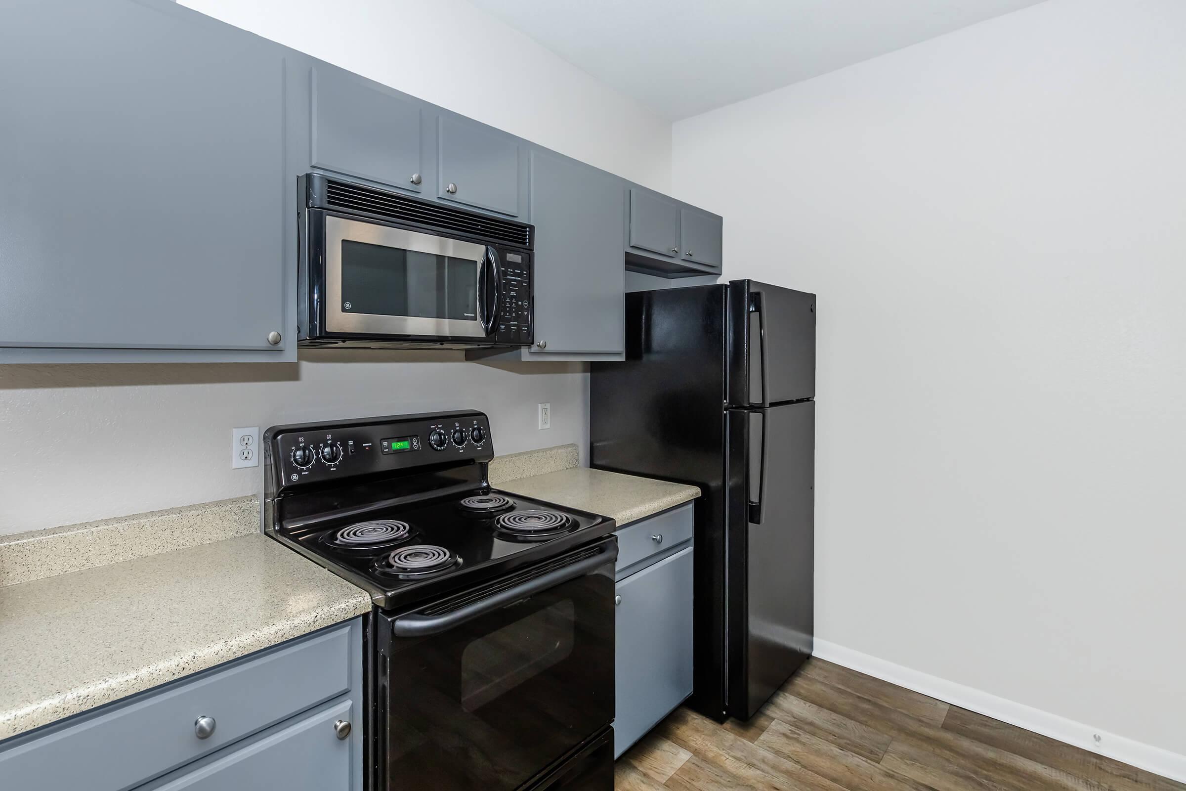 a stove top oven sitting inside of a kitchen