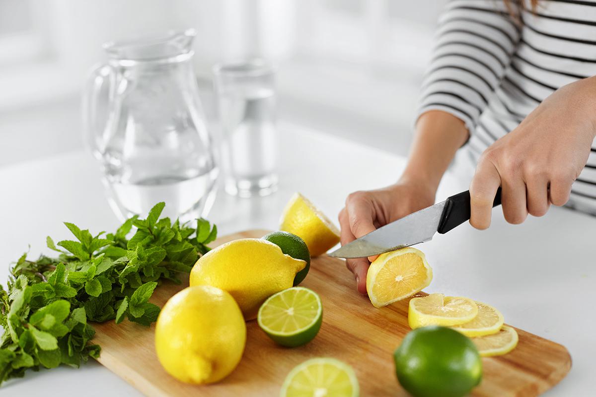 a person with a knife on a cutting board with a cake