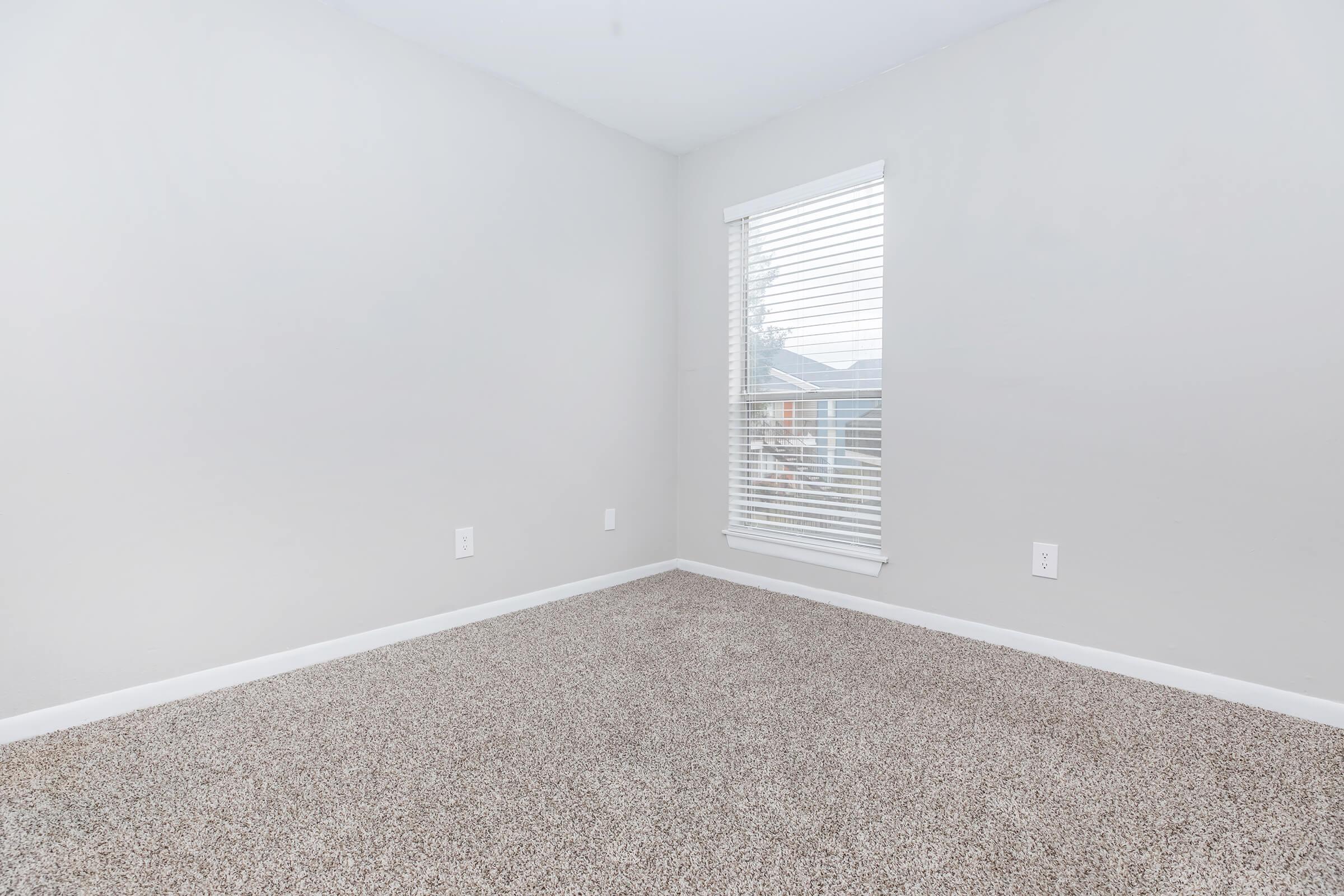 a bedroom with a large window