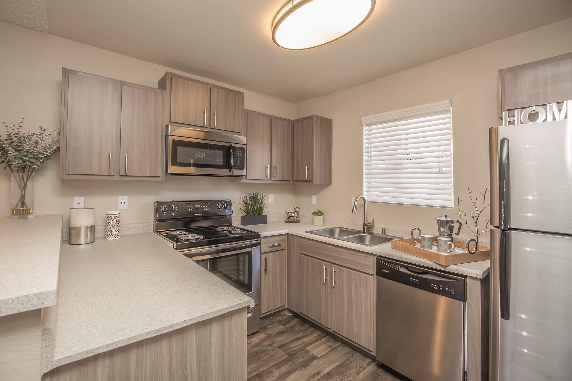 a kitchen with stainless steel appliances and wooden cabinets