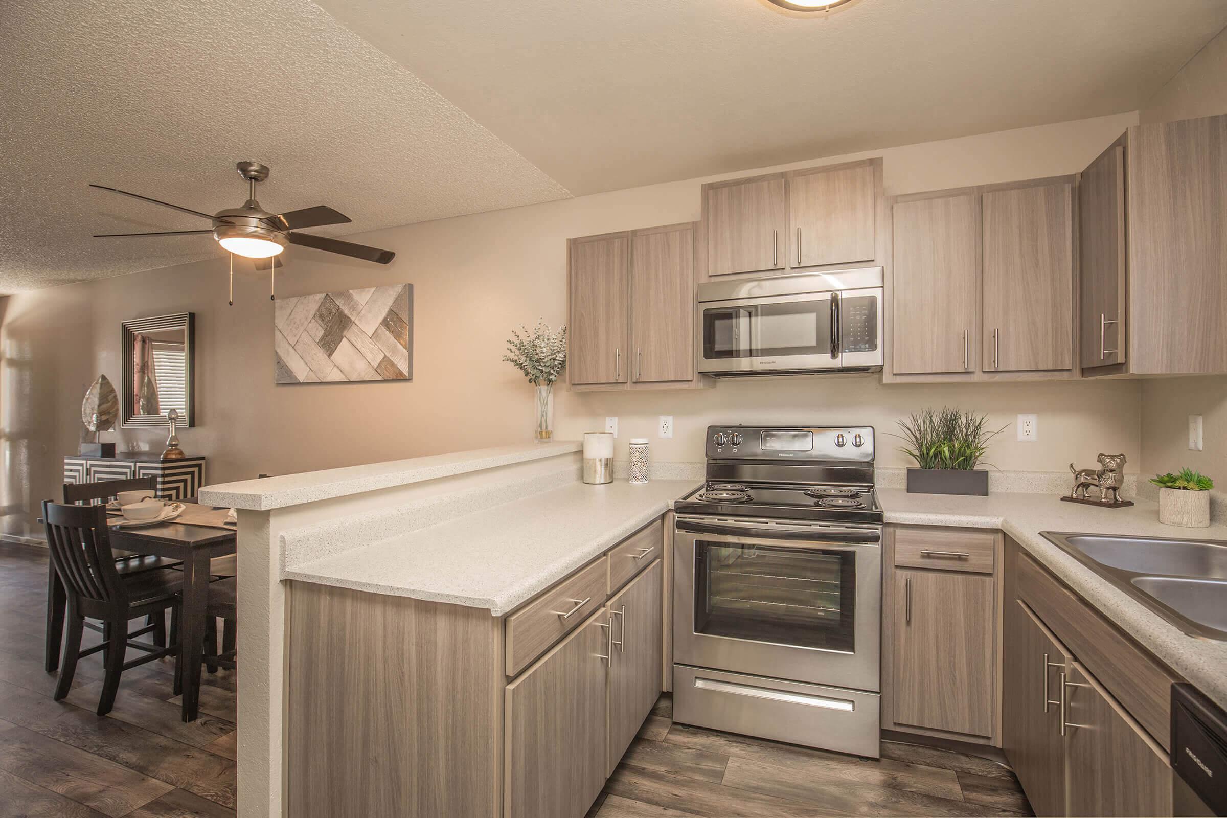 a kitchen with stainless steel appliances and wooden cabinets