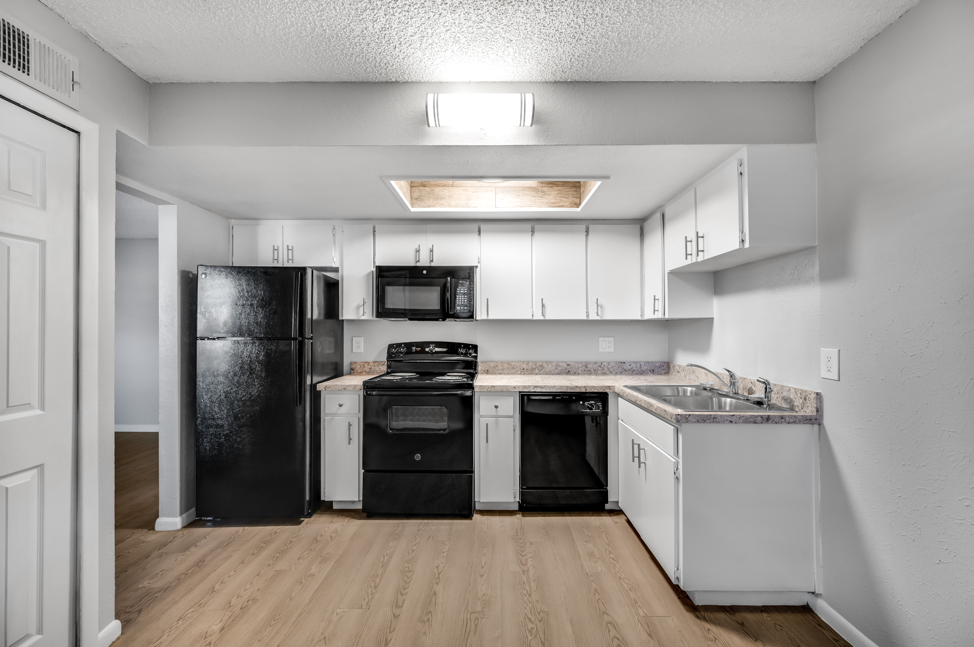 a kitchen with a stove and a refrigerator